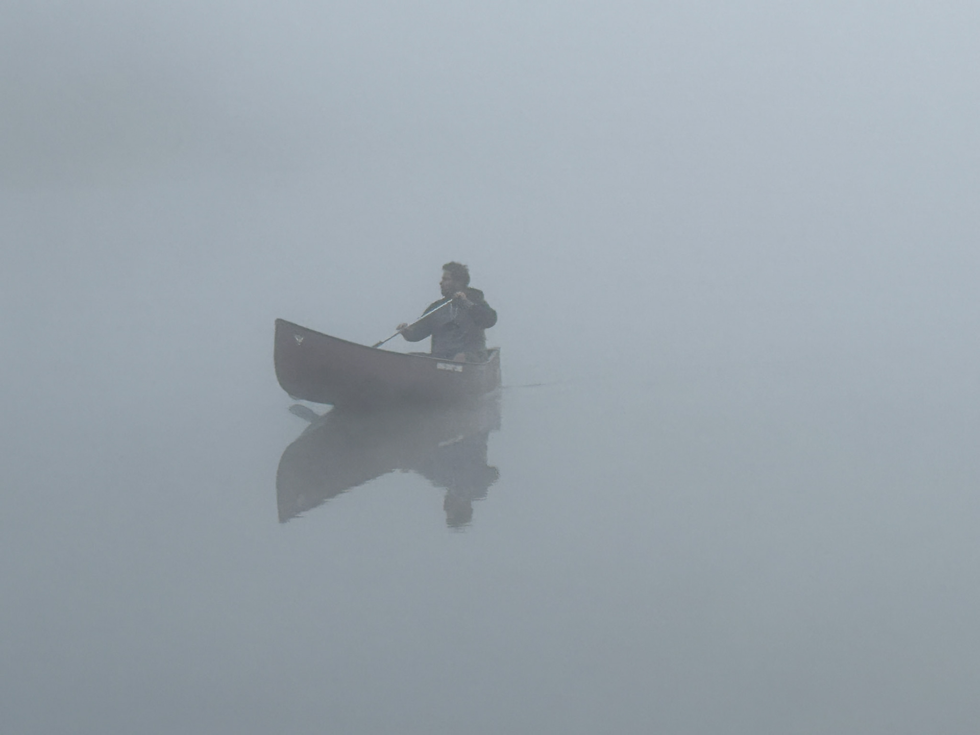 I ventured to Kearney Lake and saw a solo canoeist paddling to shore through the mist