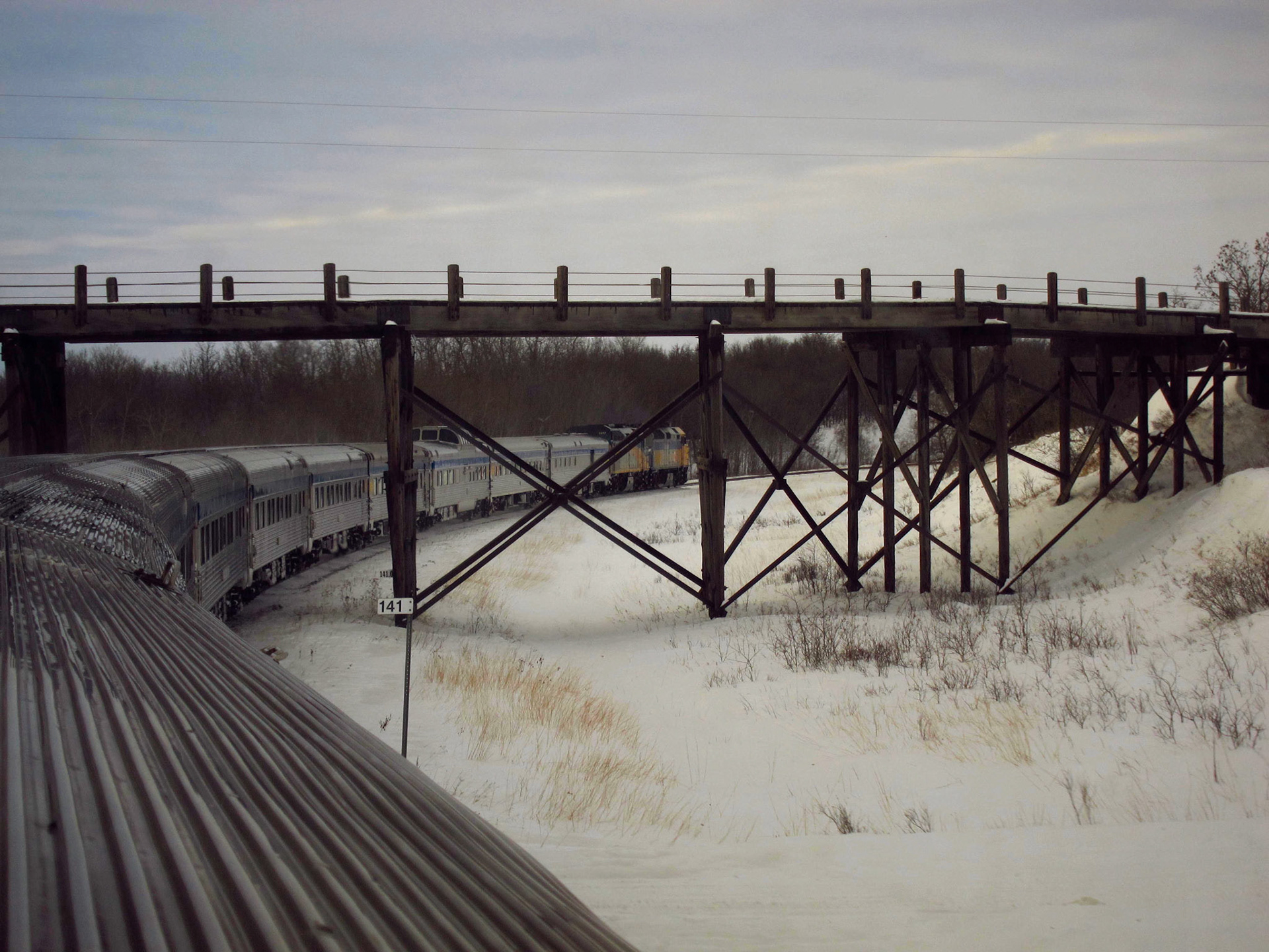 The Canadian passes under a bridge