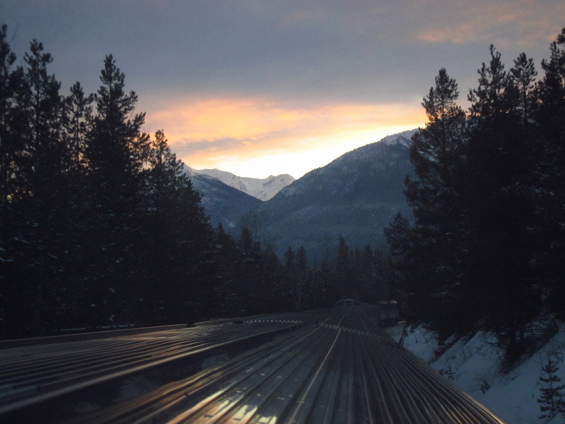 The sun sets as The Canadian navigates the Rockies