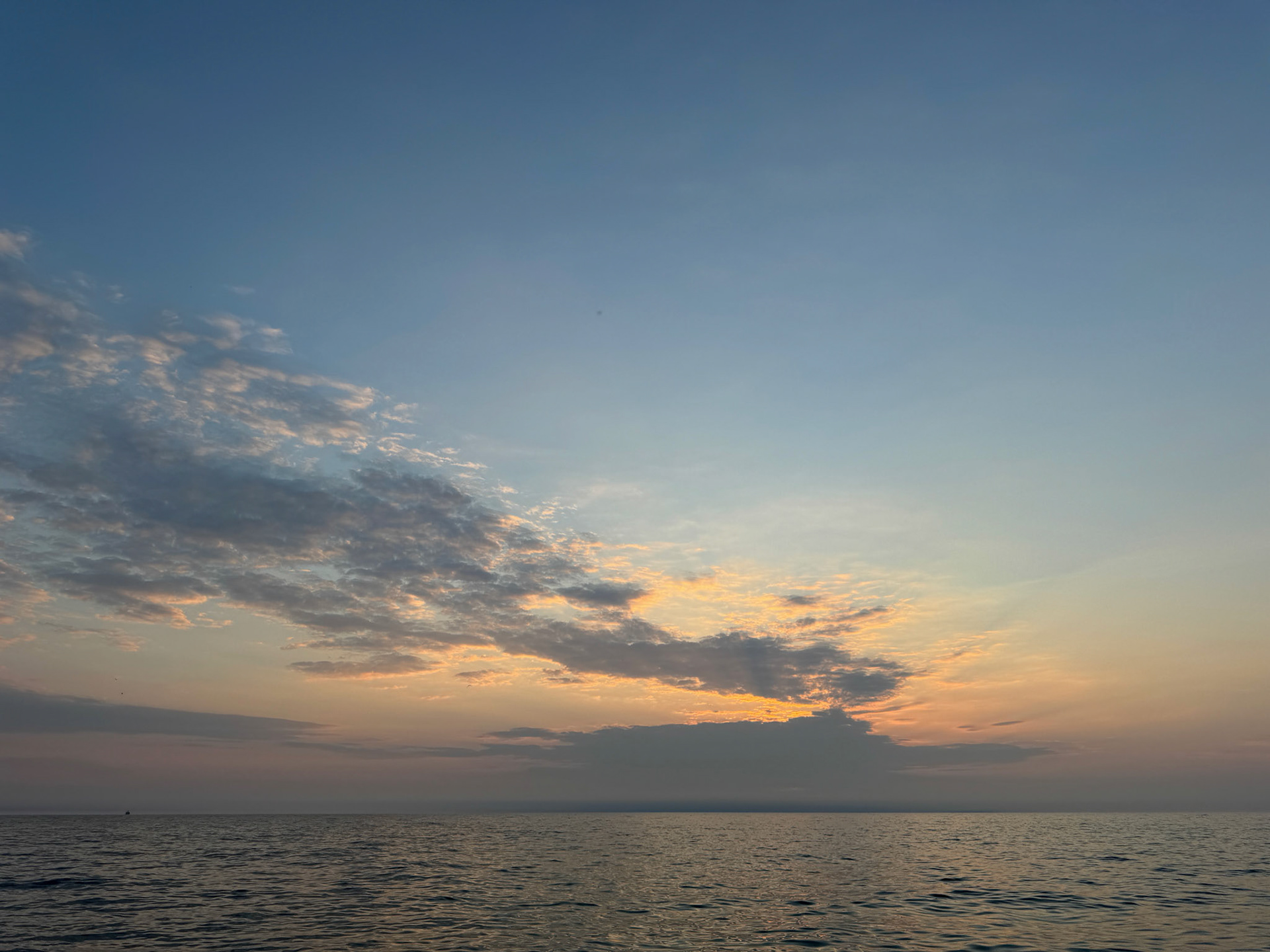 The sun begins to rise over Lake Michigan