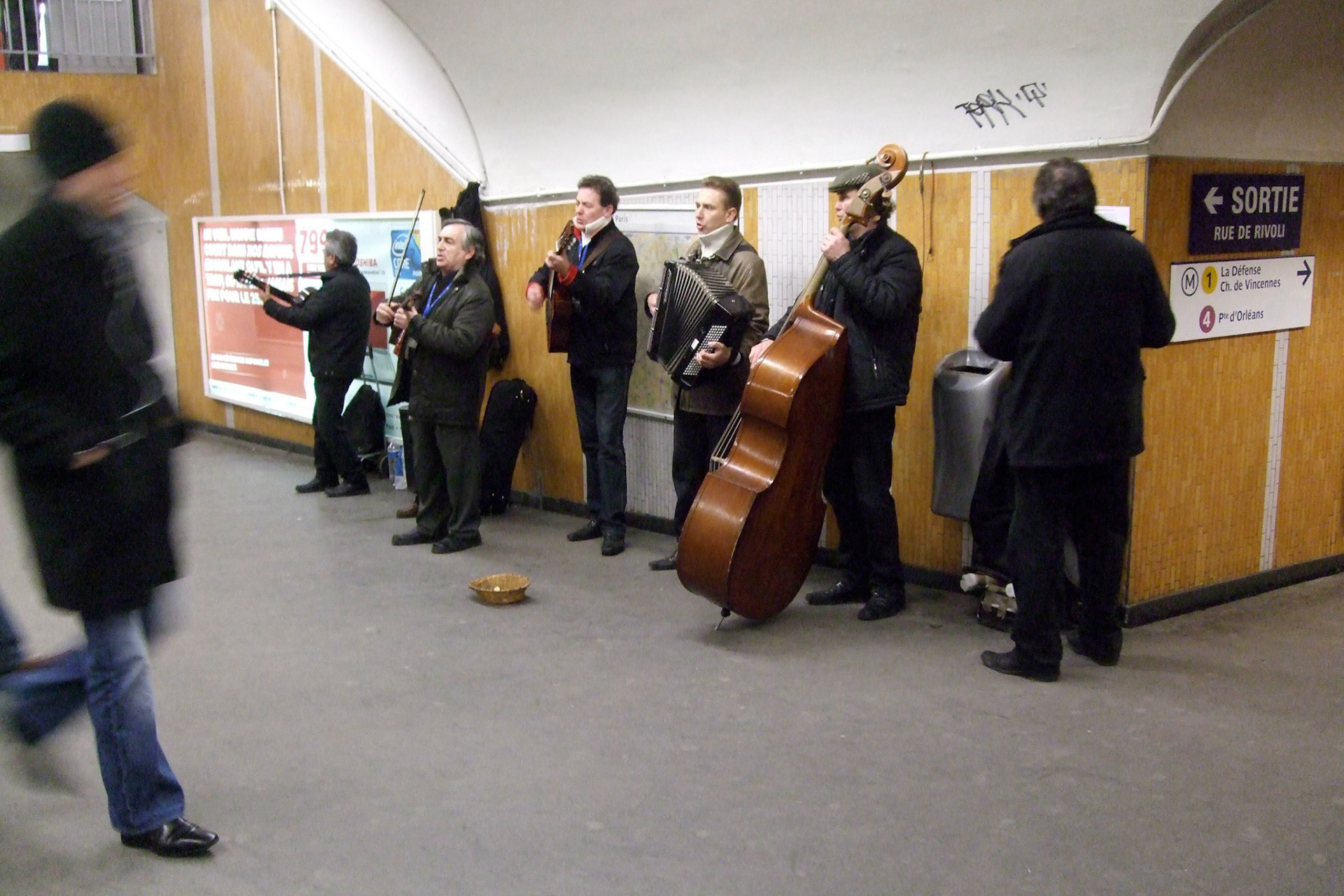 A band playing traditional french music in the metro station