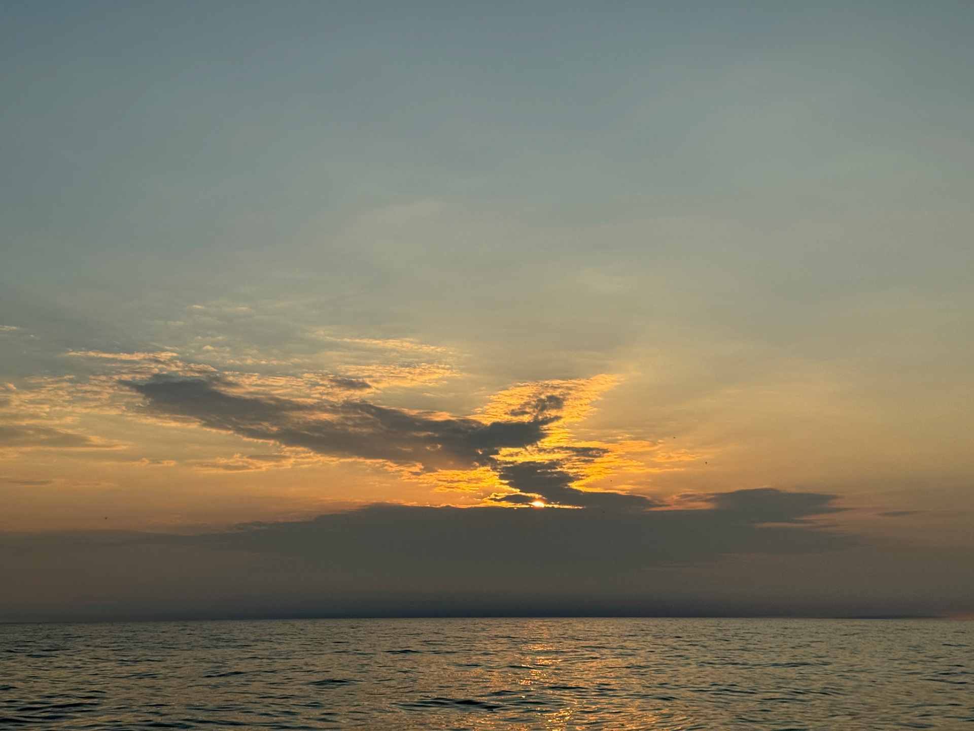 The sun begins to rise over Lake Michigan at North Avenue Beach