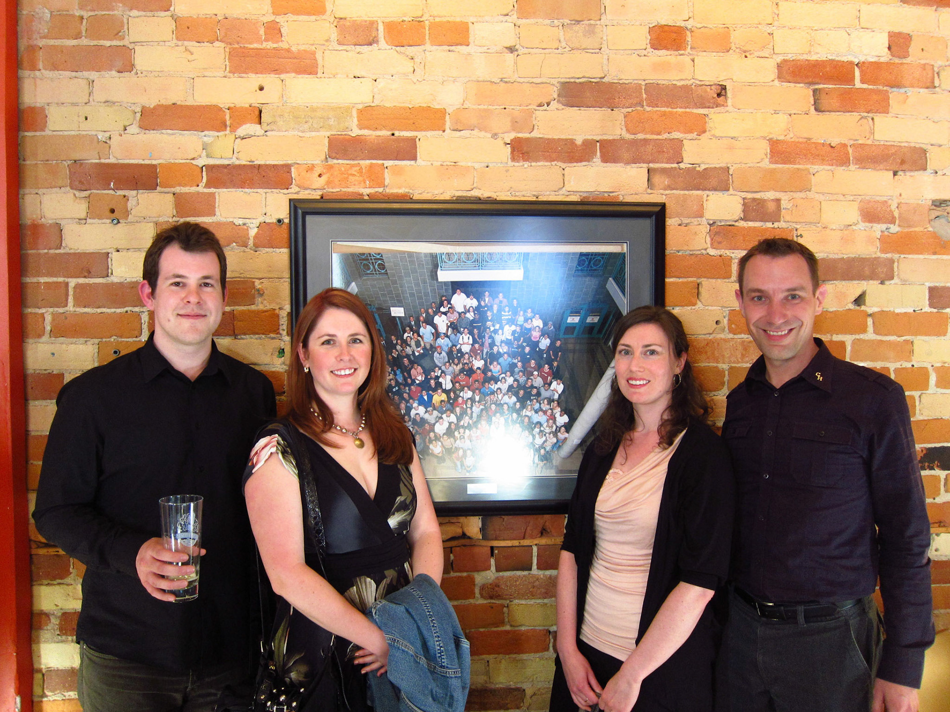 5 years after we graduated, Matt, Erin Hannah and I stand beside the photo taken on the inaugural day of Guelph-Humber