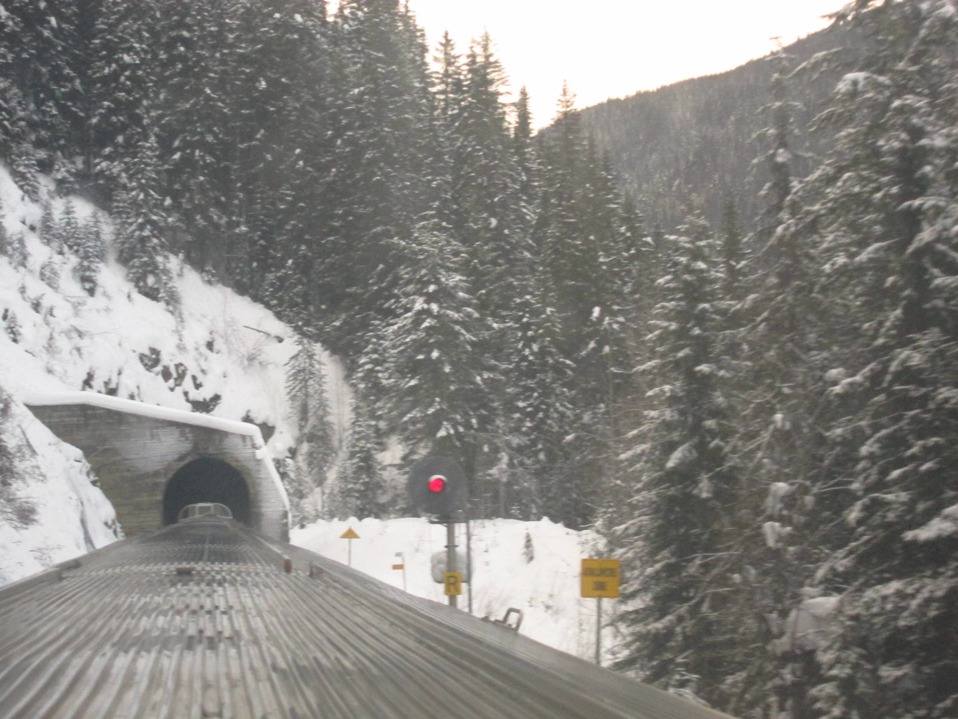 The yellow sign before the tunnel says "Avalanche Zone"