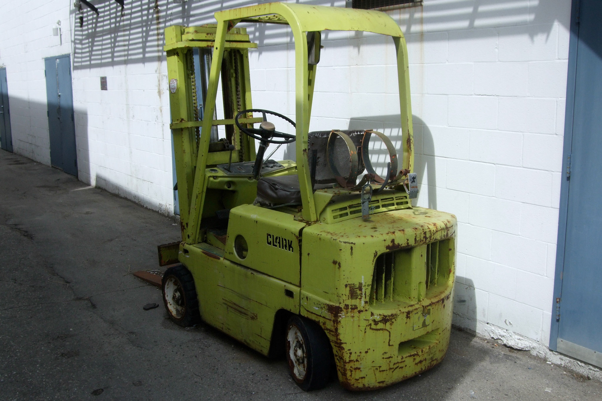A very cool find... an old, unused forklift beside a building in Old East