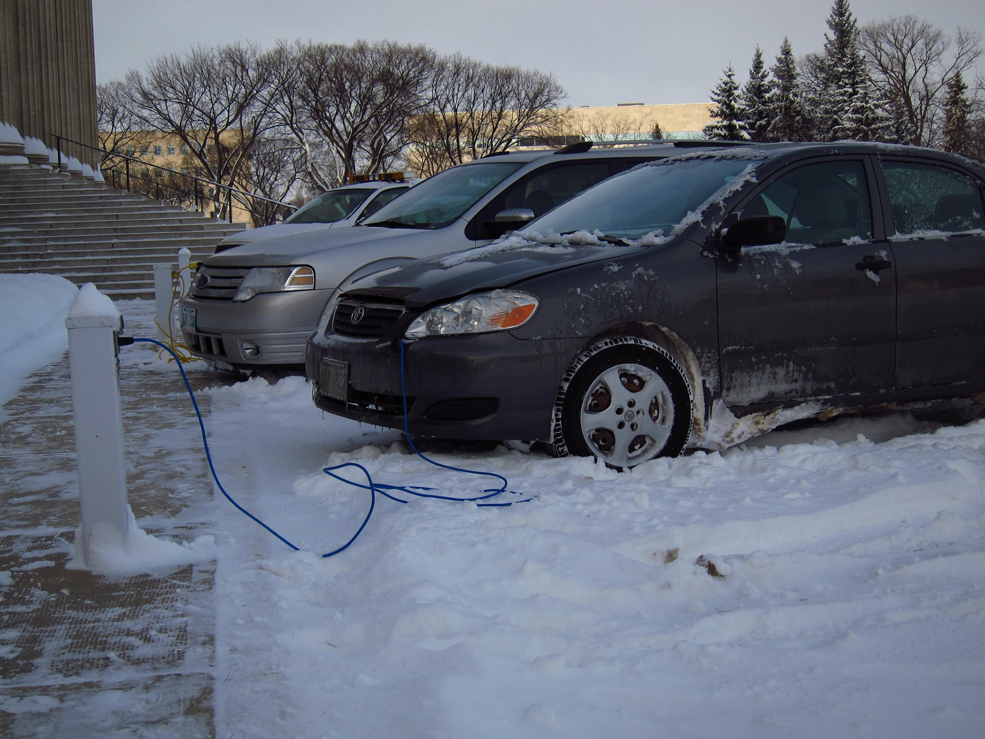 Cars parked at the Manitoba Legislature... Almost all parking lots have plugs for block heaters