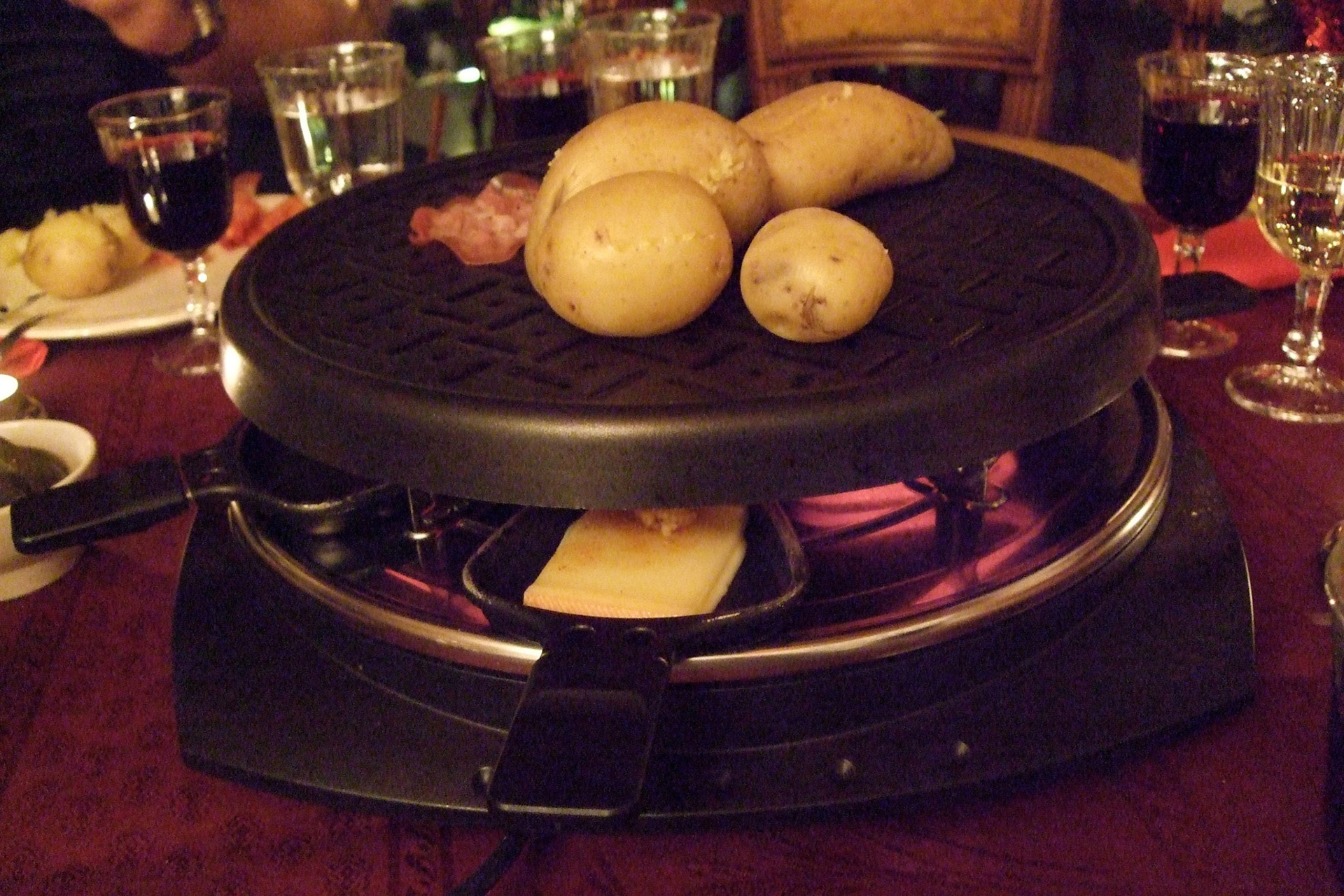 This is how the raclette grill works. The cheese melts in a little pan underneath; potatoes and meat grill up above