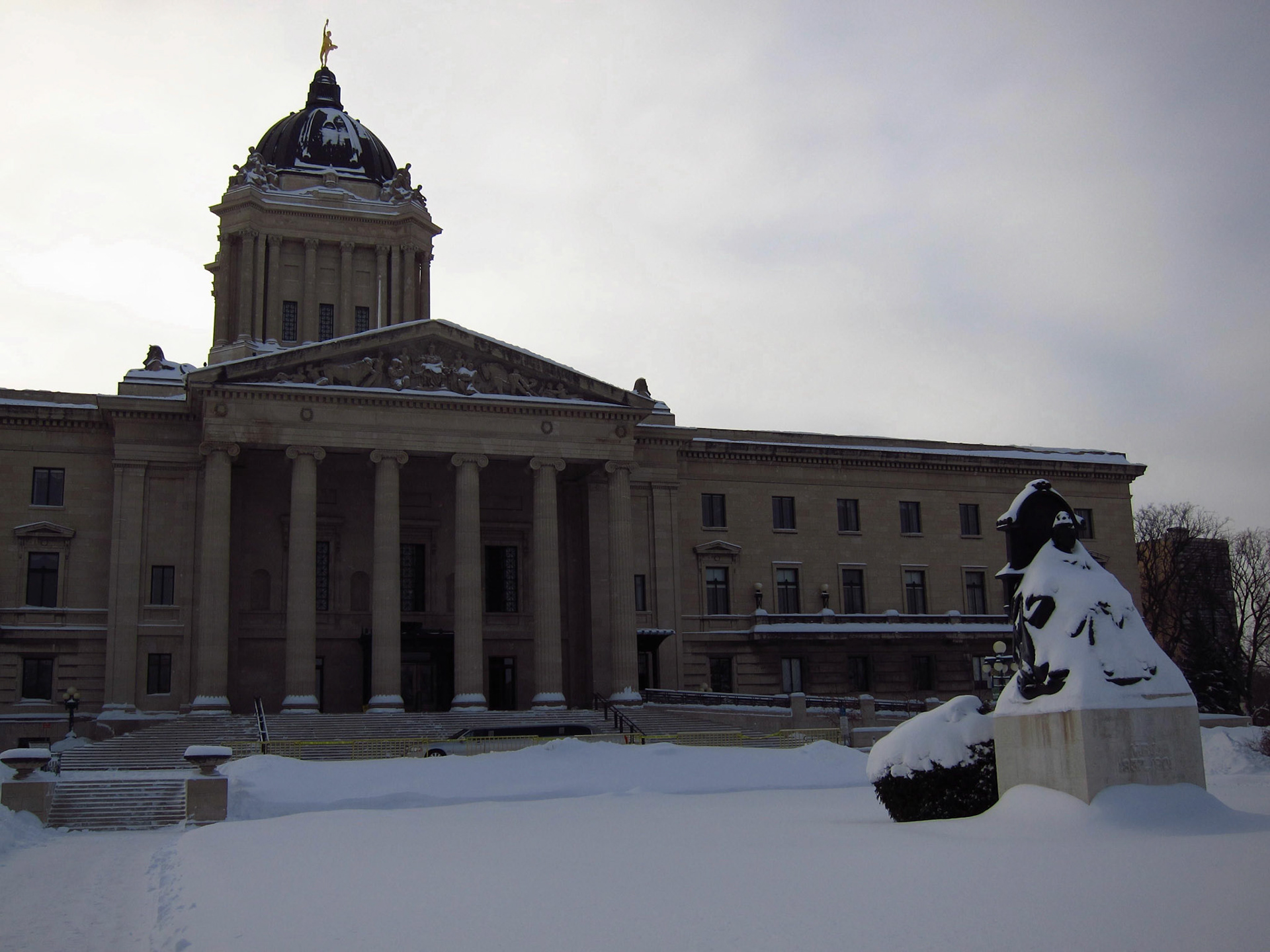 Queen Victoria - with a white winter coat - sits in front of the Manitoba Legislature