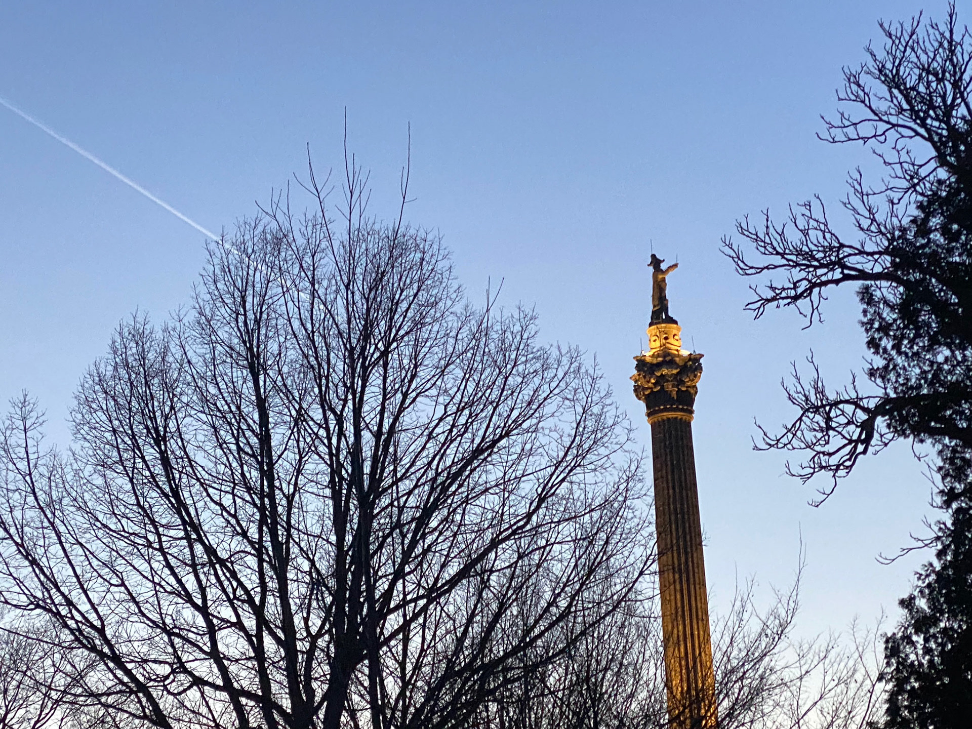 The sun sets behind the Brock Monument