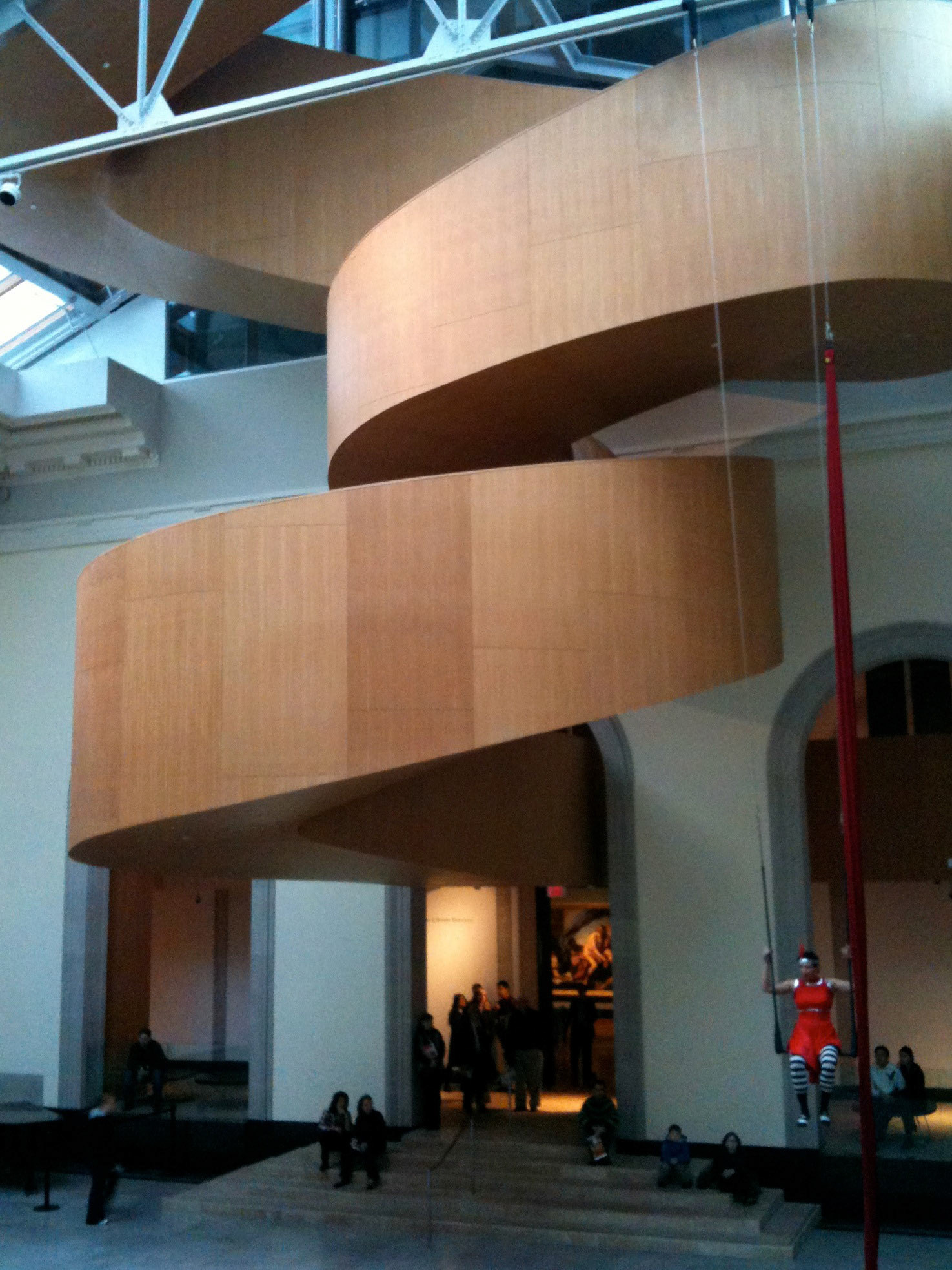 An artist was doing some sort of acrobatic theatre performance in front of the super-funky staircase