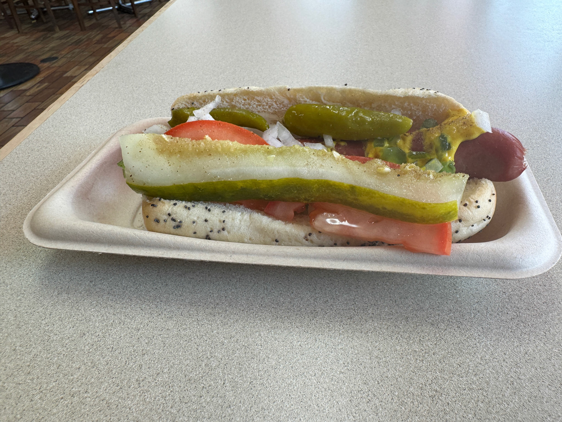 Chicago-style hot dogs are a bit bizarre, but they work. Yellow mustard, chopped white onions, green sweet pickle relish, a dill pickle spear, tomato slices, pickled sport peppers and a dash of celery salt.