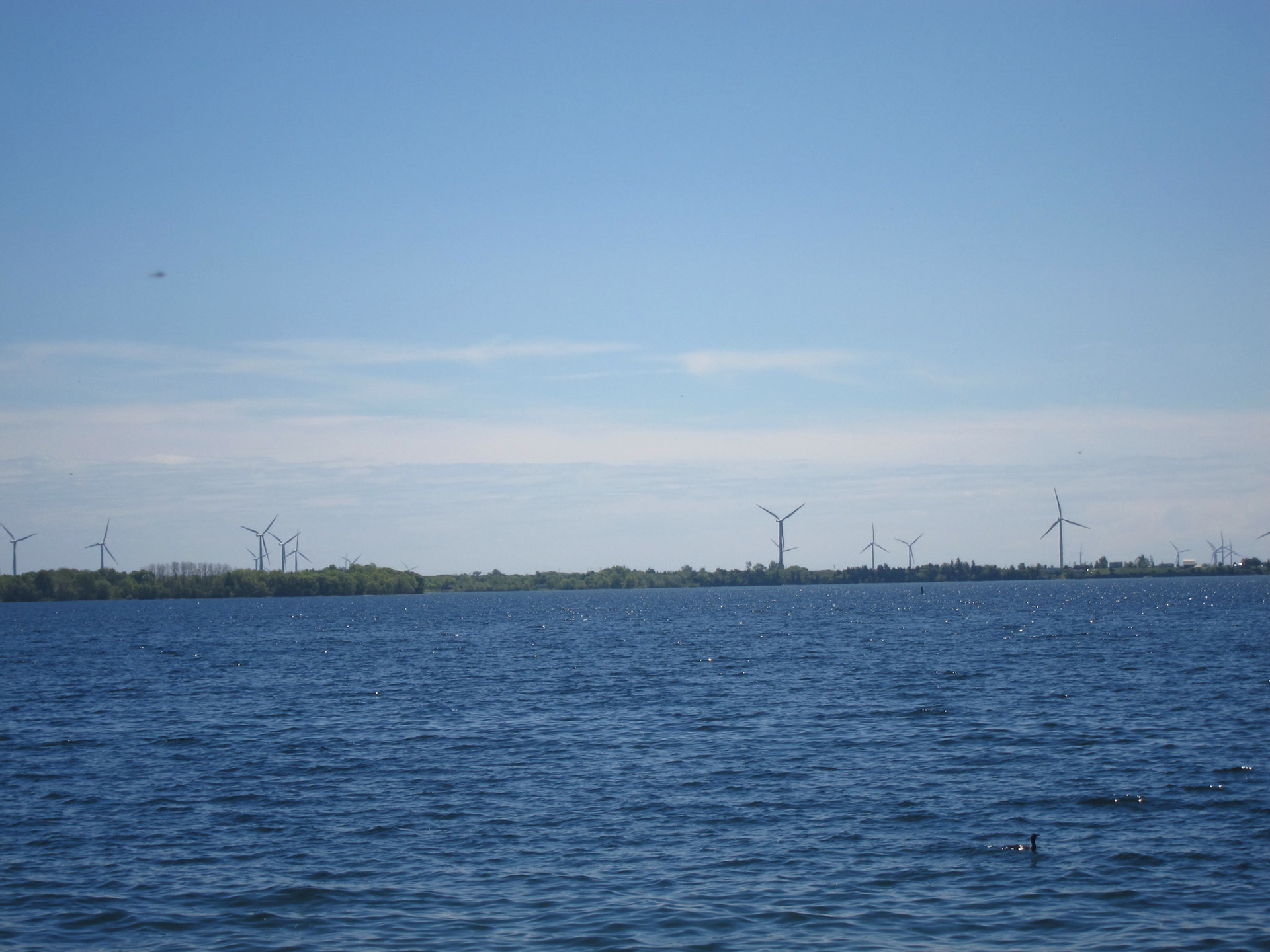 The blue waters of Lake Ontario and majestic wind turbines along Kingston's waterfront