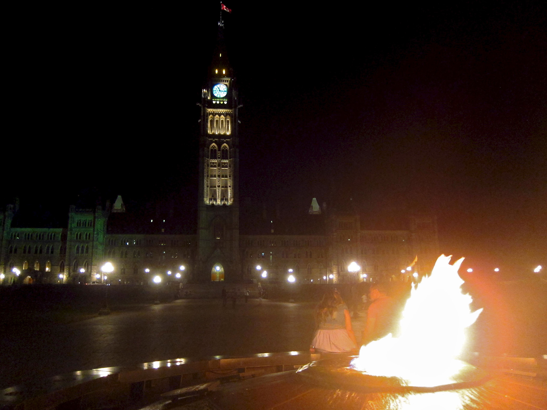 Parliament and the Peace Flame at night
