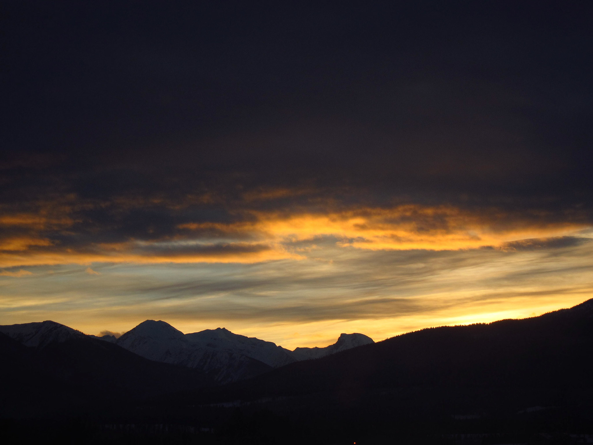 The sun sets beyond the Rocky Mountains