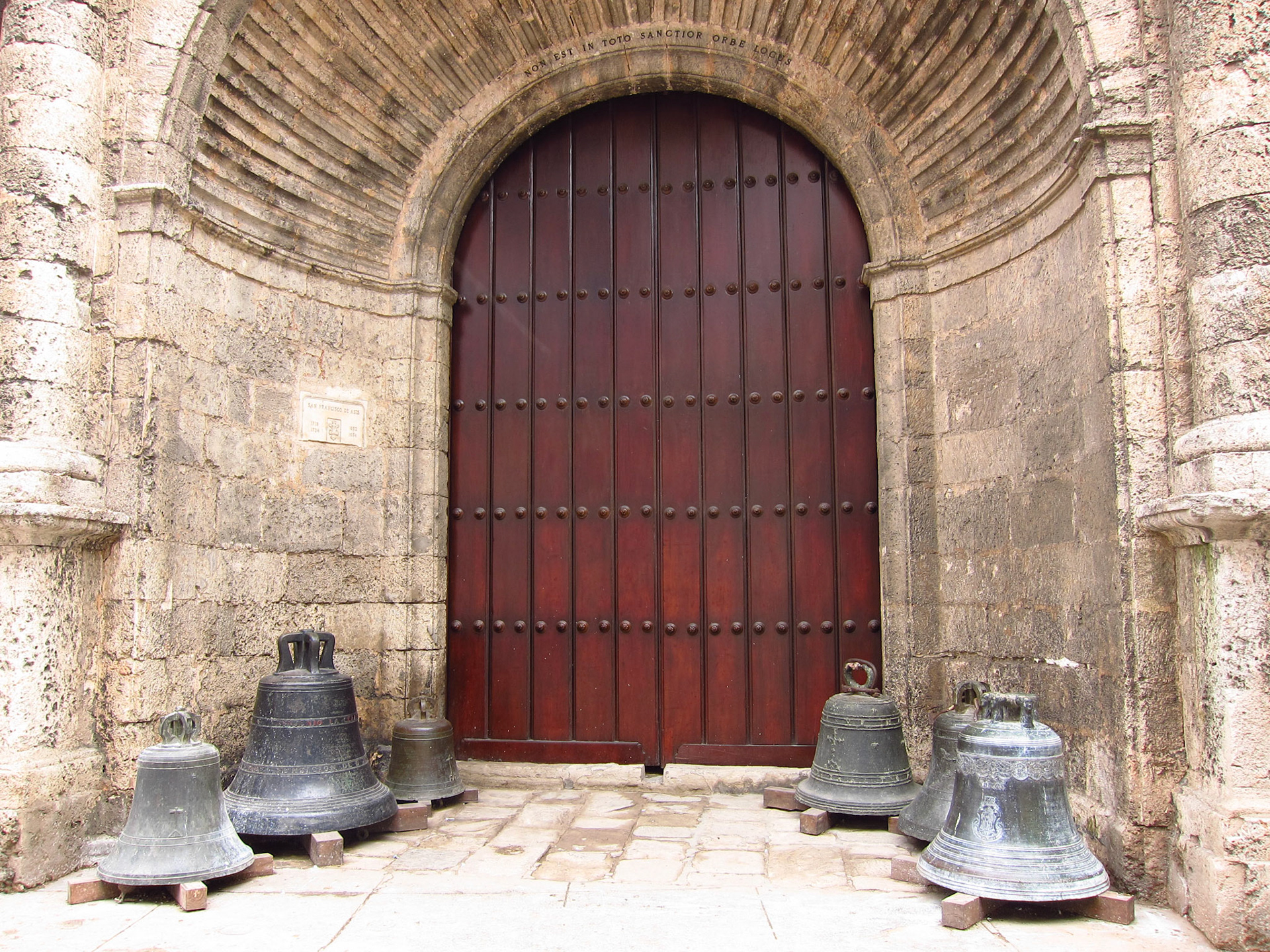 A church wiith some old bells at its doorway