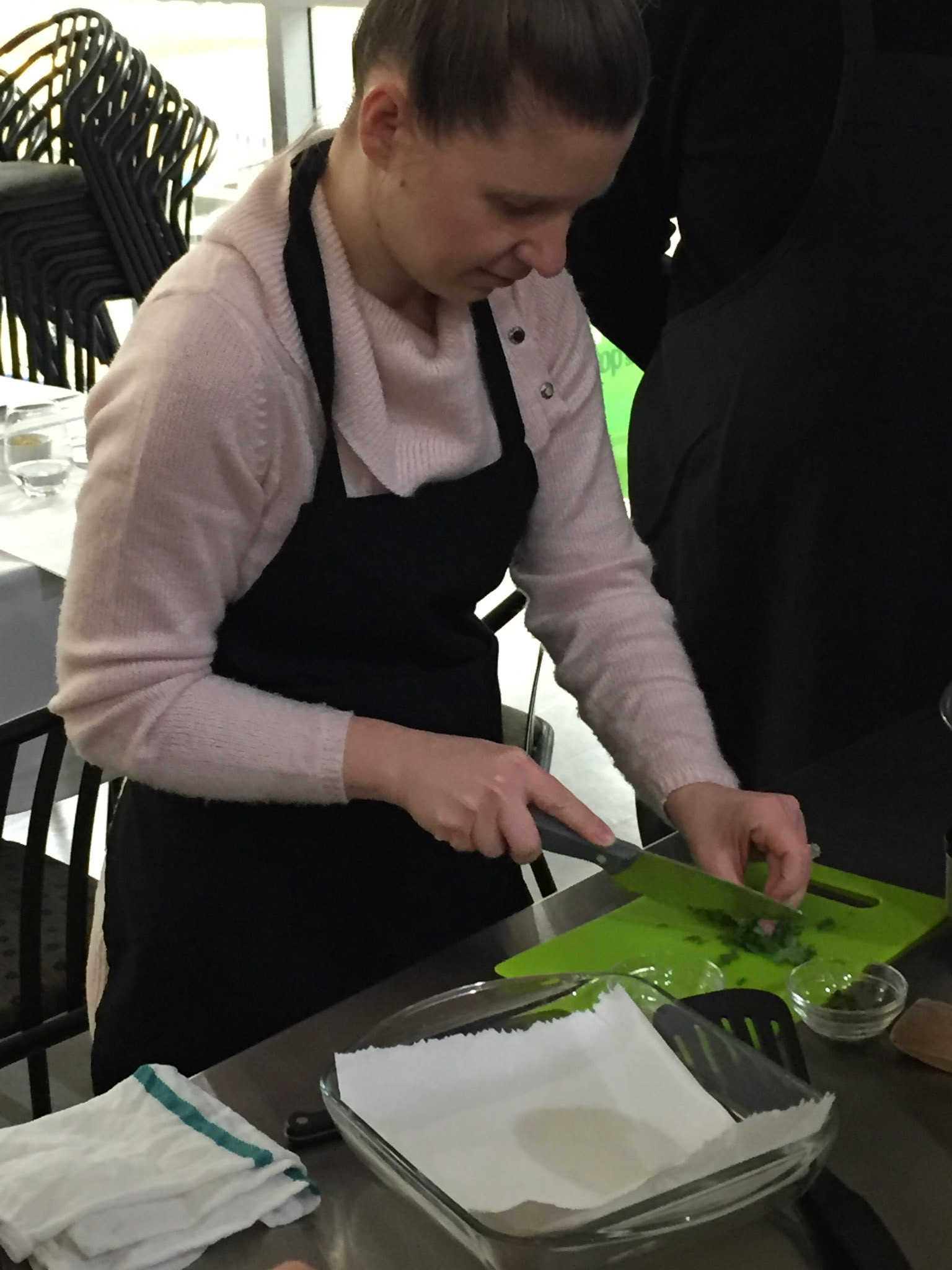Anna expertly chops the chili peppers