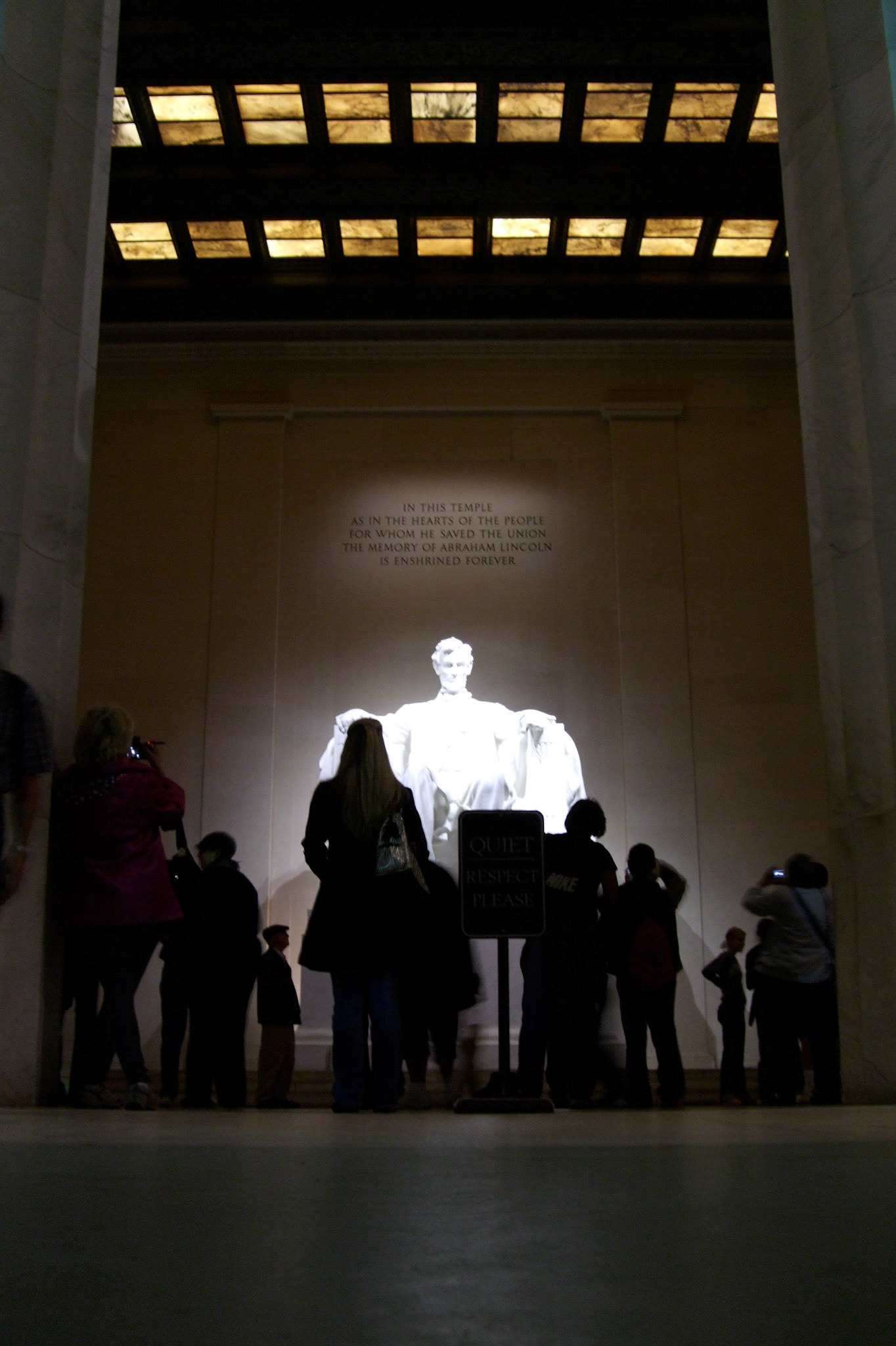 The crowd is dwarfed by the imposing Lincoln statue