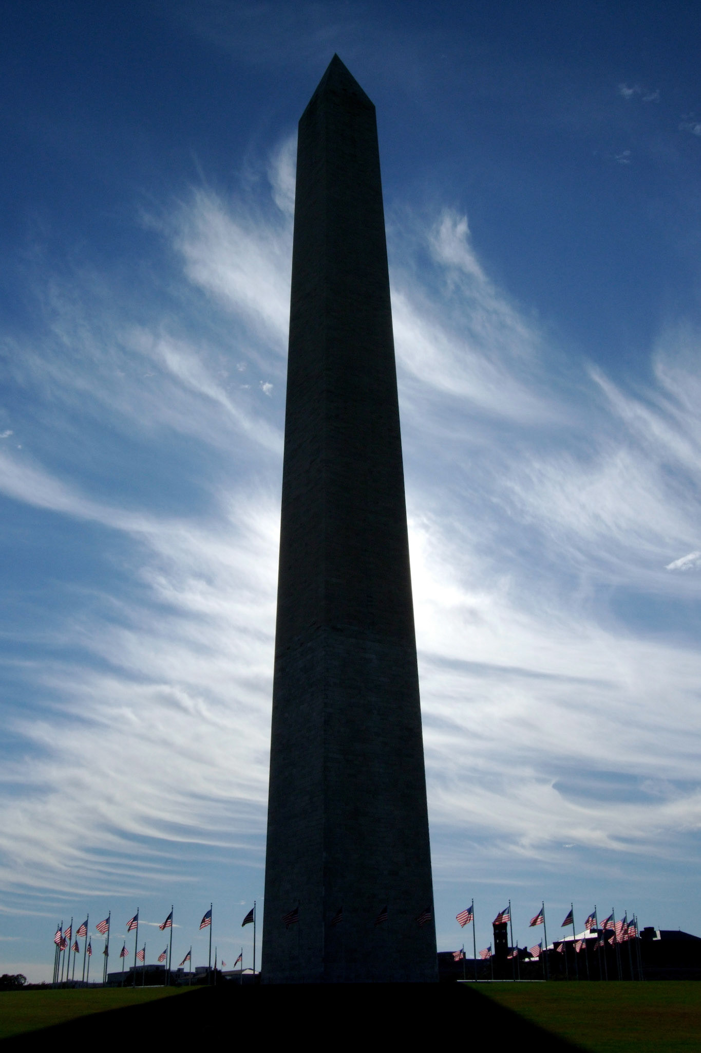 Slightly different exposure - silhouette of the Washington Monument with the flags lit up by sunlight