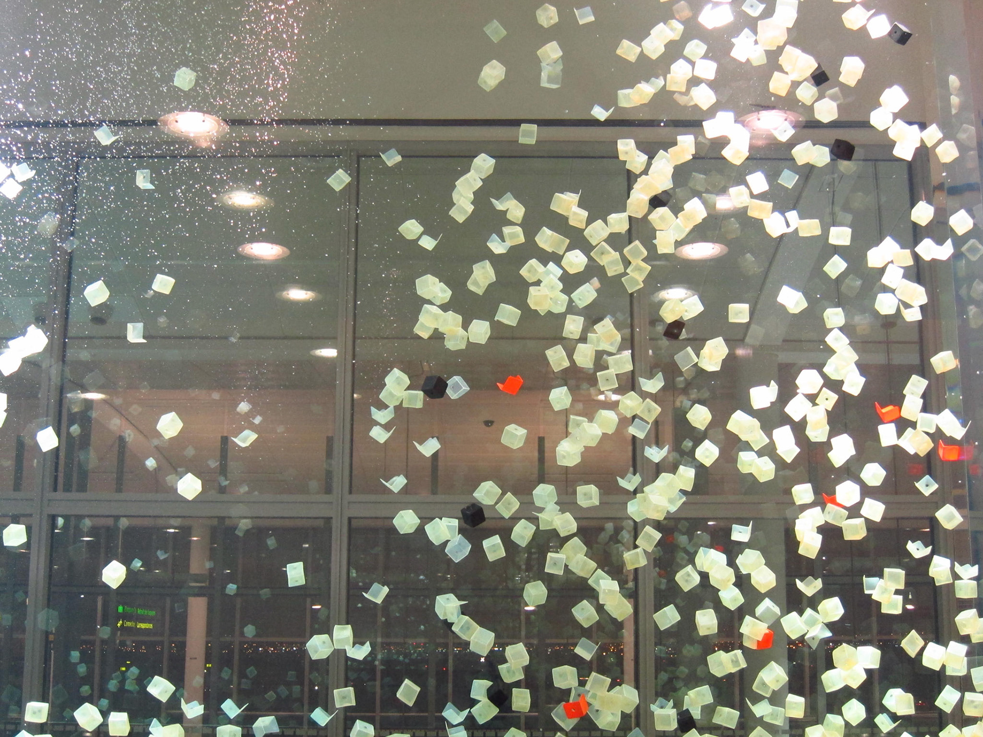 Stunning artwork at Toronto Pearson Airport: translucent cubes spin in a giant aquarium