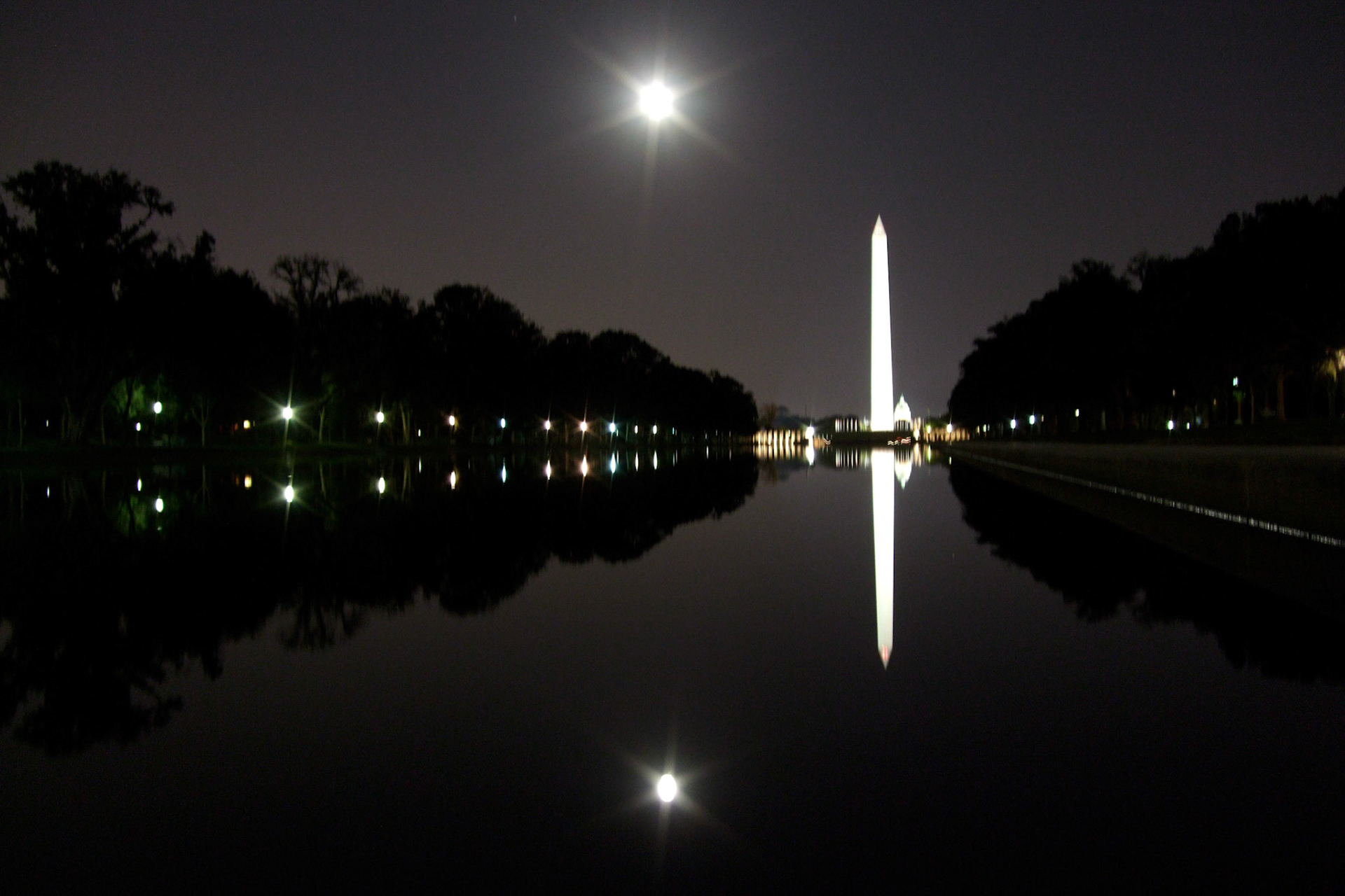 The famous reflecting pool... reflecting the nighttime view of the Capitol Building in the distance, the Washington Monument, and a full moon