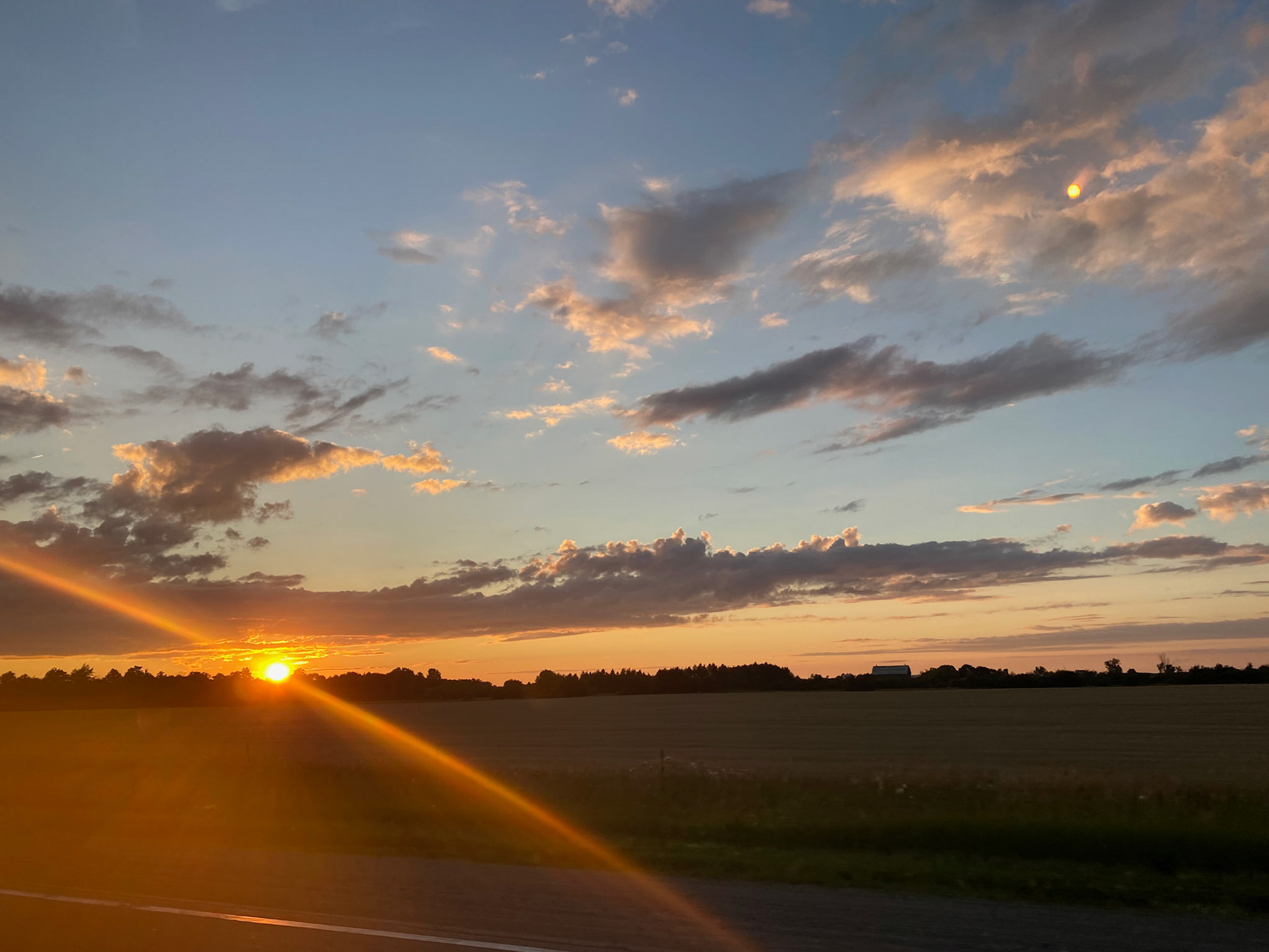 Sun and clouds and sunset during ride to the cottage - July 28-2022