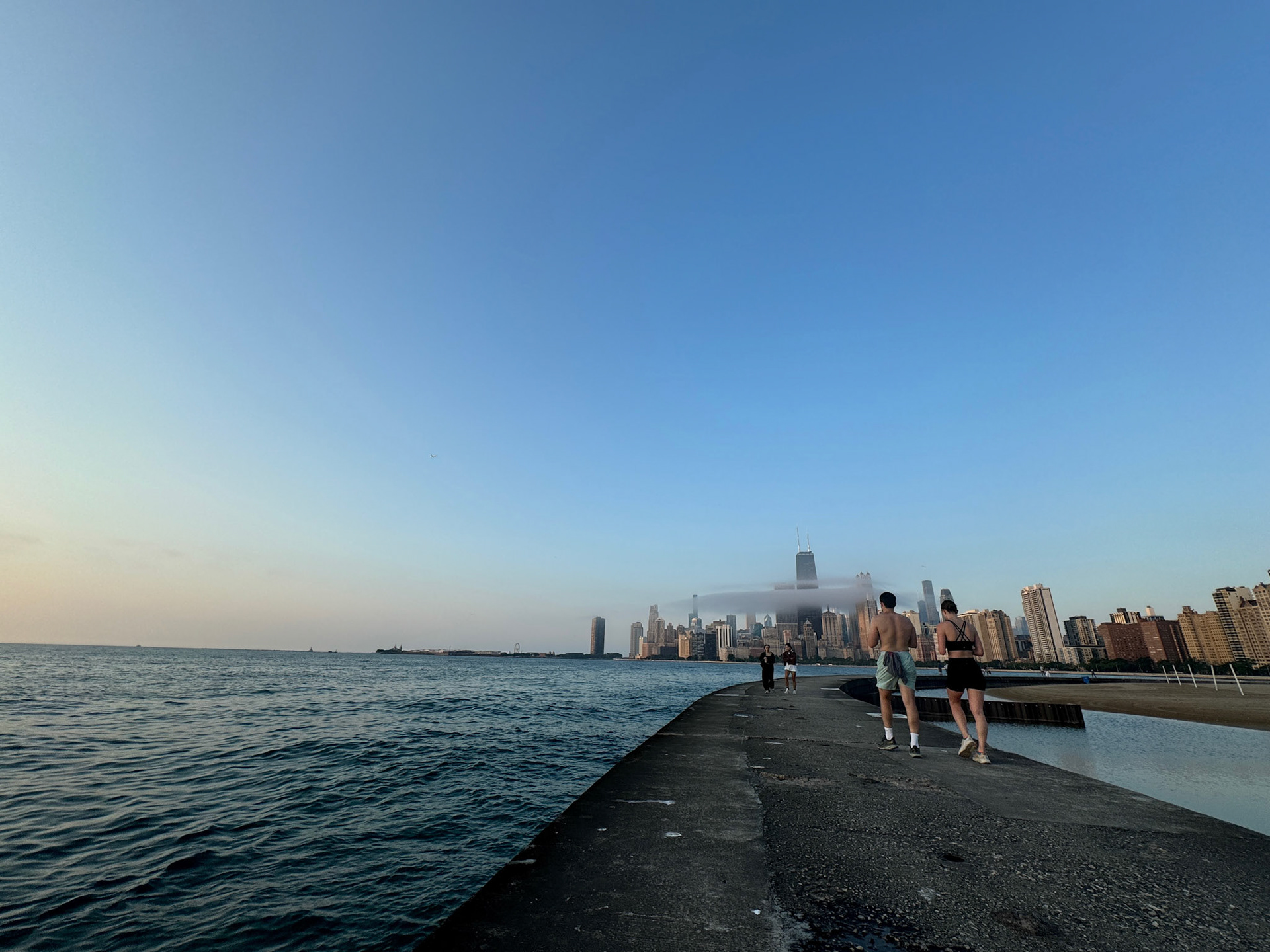 Just as the sun broke through the low clouds, a whift of mist appeared over the bay around Chicago's Gold Coast in front of the skyline