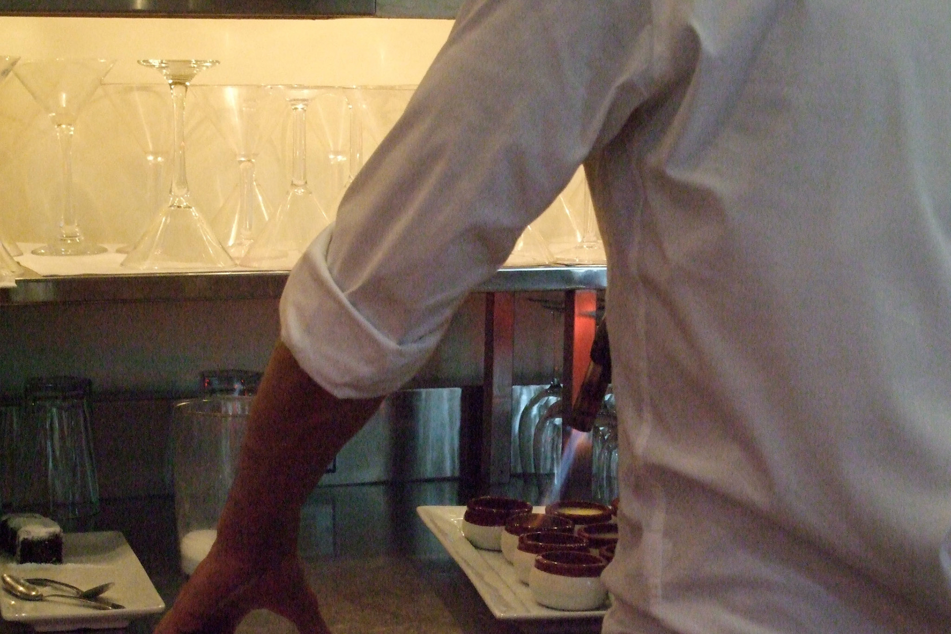 A chef brulees some creme brulees