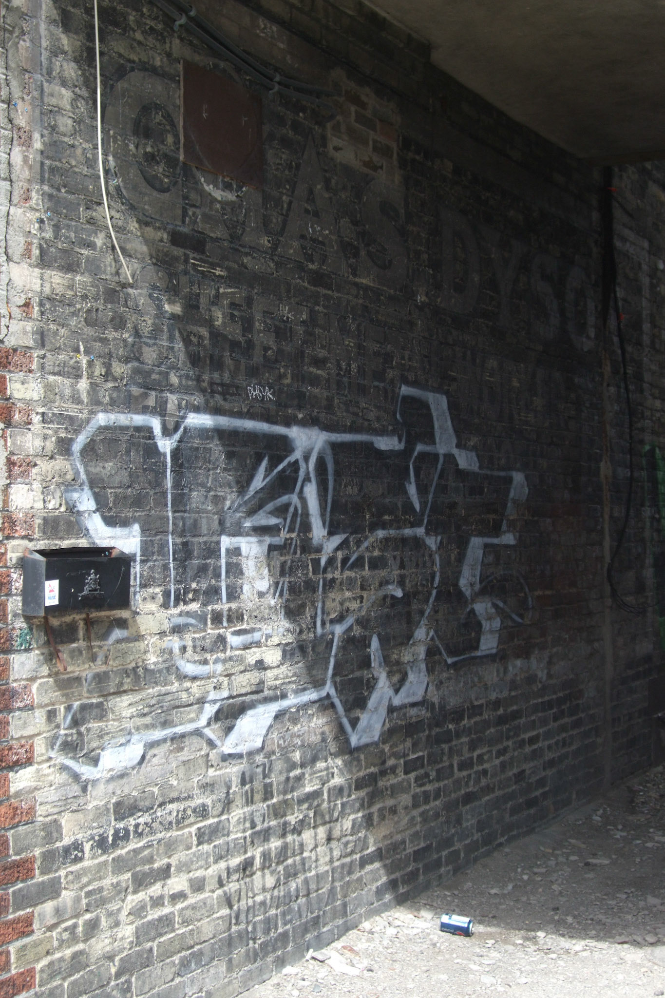 A mailbox at the entrance to a very old alley-way