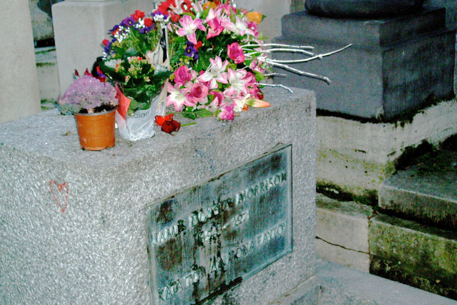 Pere Lachaise's major tourist draw: Jim Morrison's grave. Surprised after everyone had talked about going to see it how simple the grave marker is.