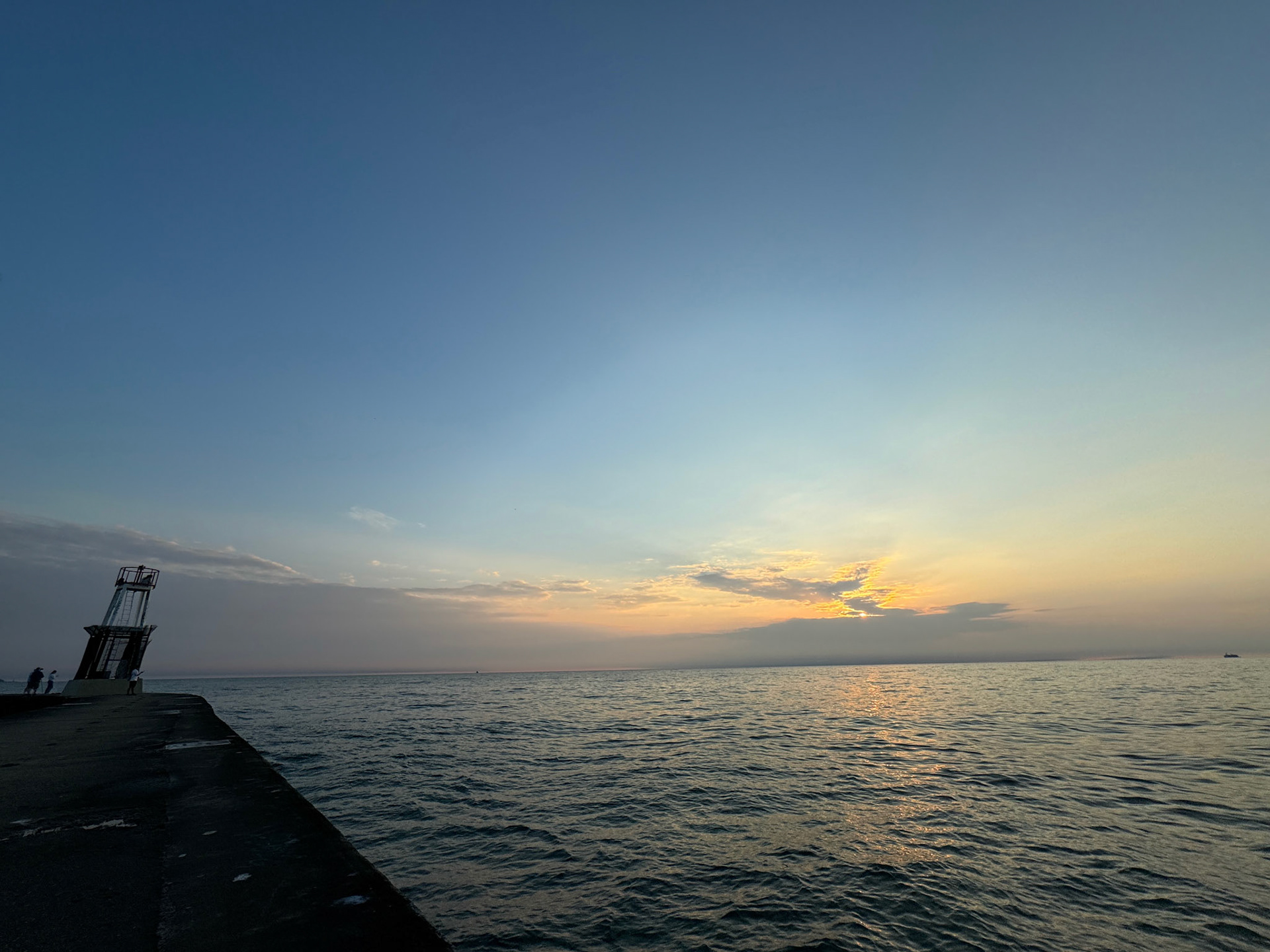 The sun begins to rise over Lake Michigan at North Avenue Beach