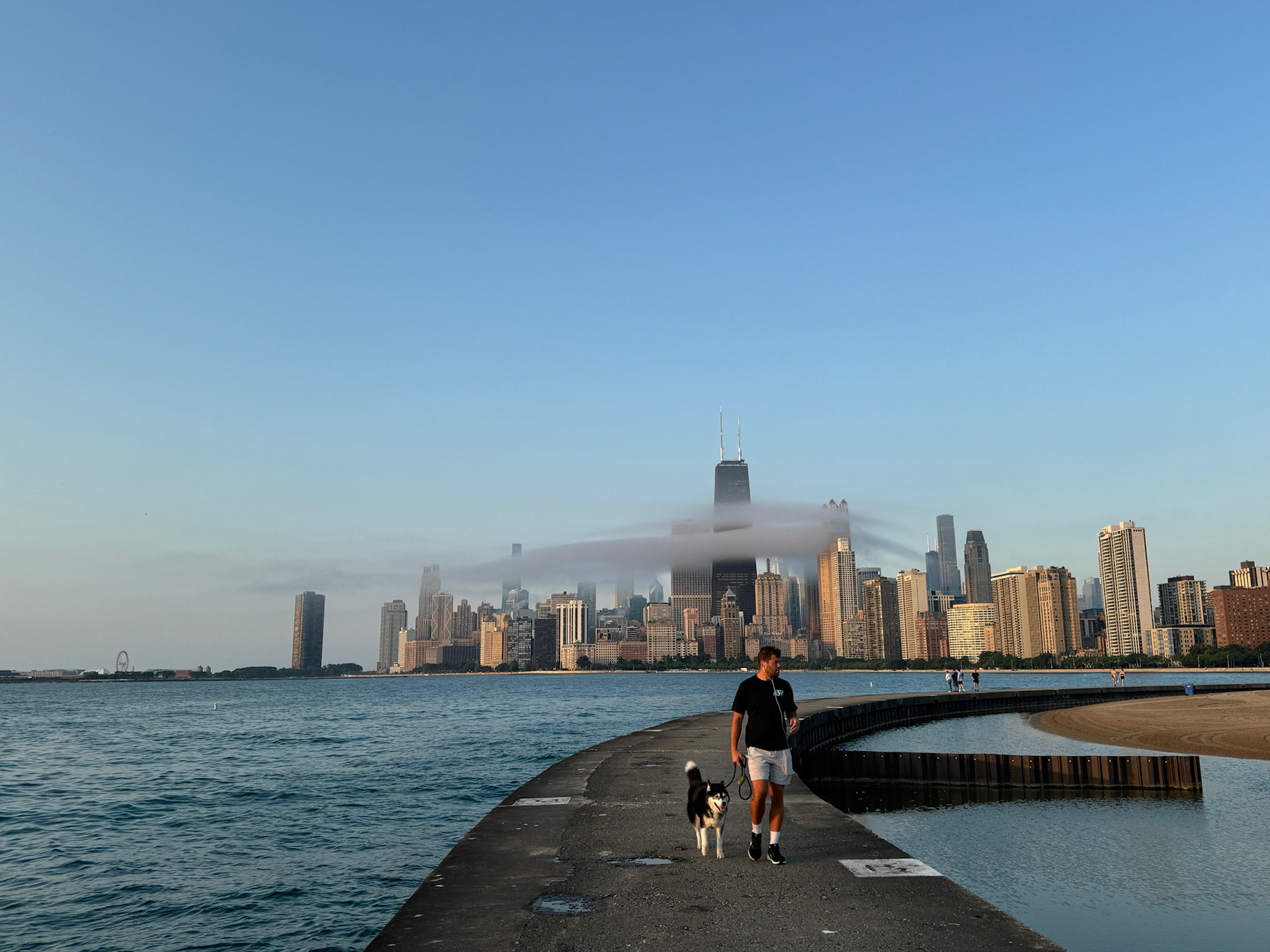Just as the sun broke through the low clouds, a whift of mist appeared over the bay around Chicago's Gold Coast in front of the skyline