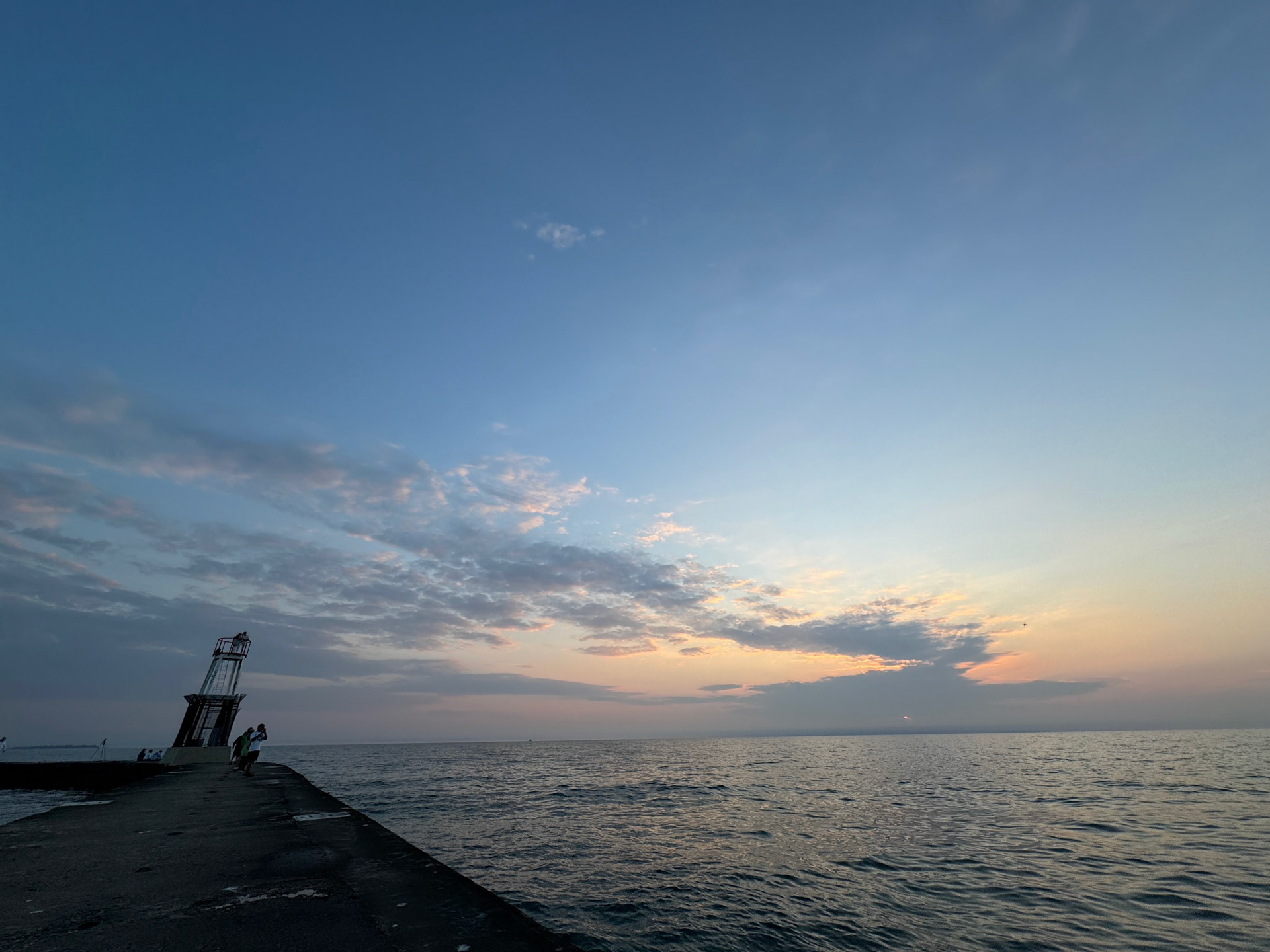 The sun begins to rise over Lake Michigan