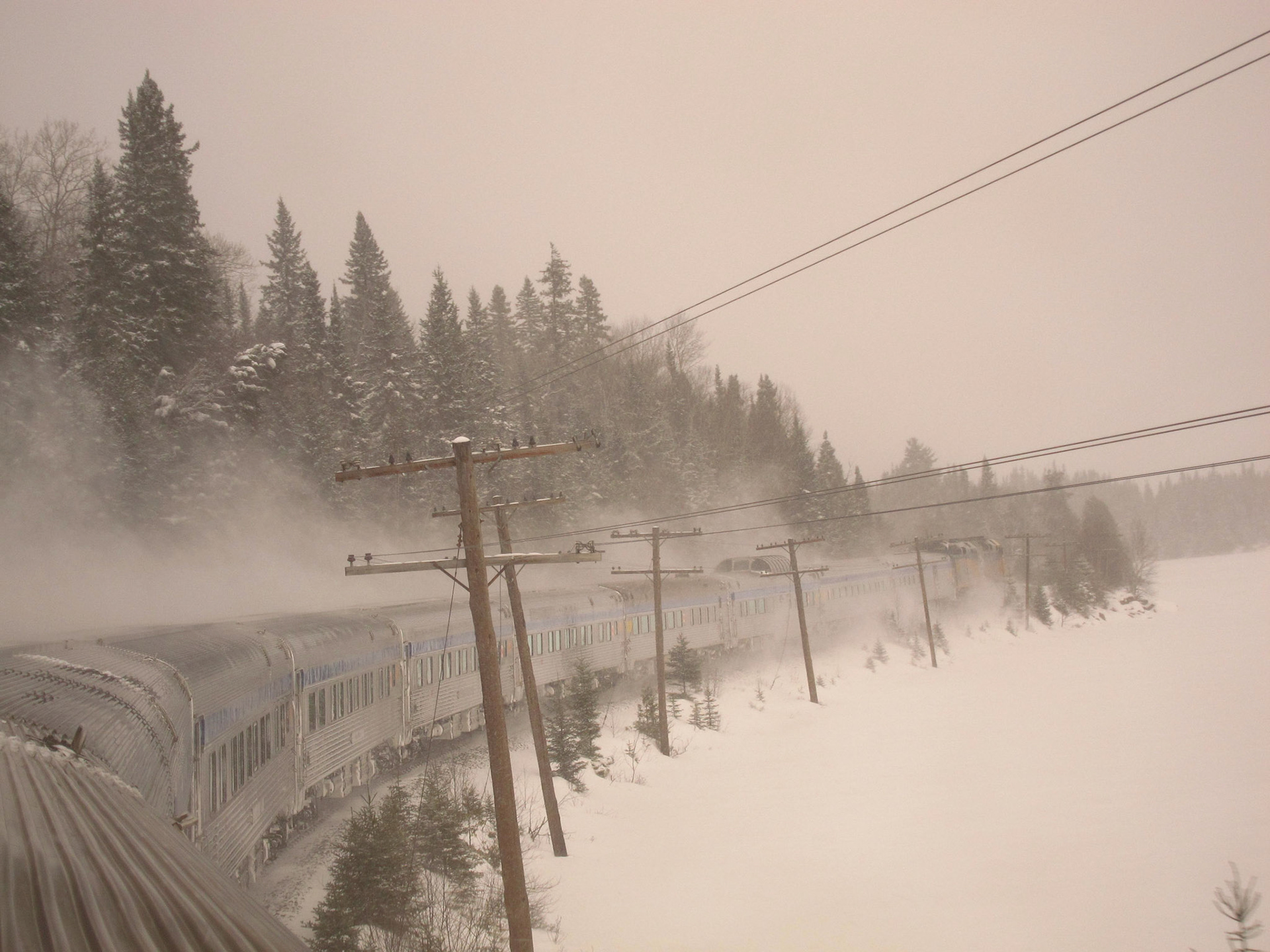 The Canadian kicks up lots of snow as it flies through the Northern Ontario forests