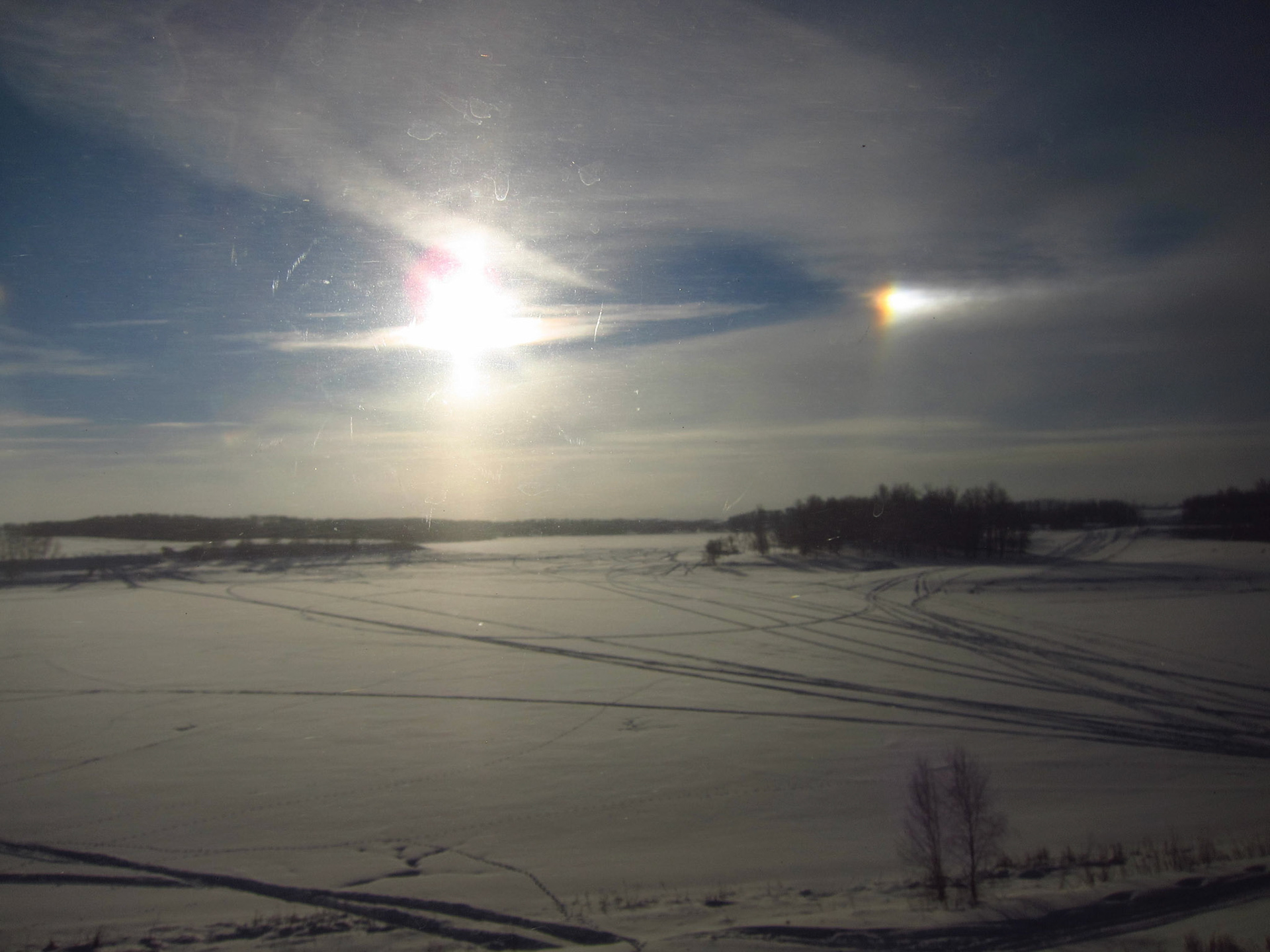 An amazing and rare sight: a sundog! The rainbow to the right of the sun is caused by light reflecting through ice crystals in the atmosphere. That's how cold it is!