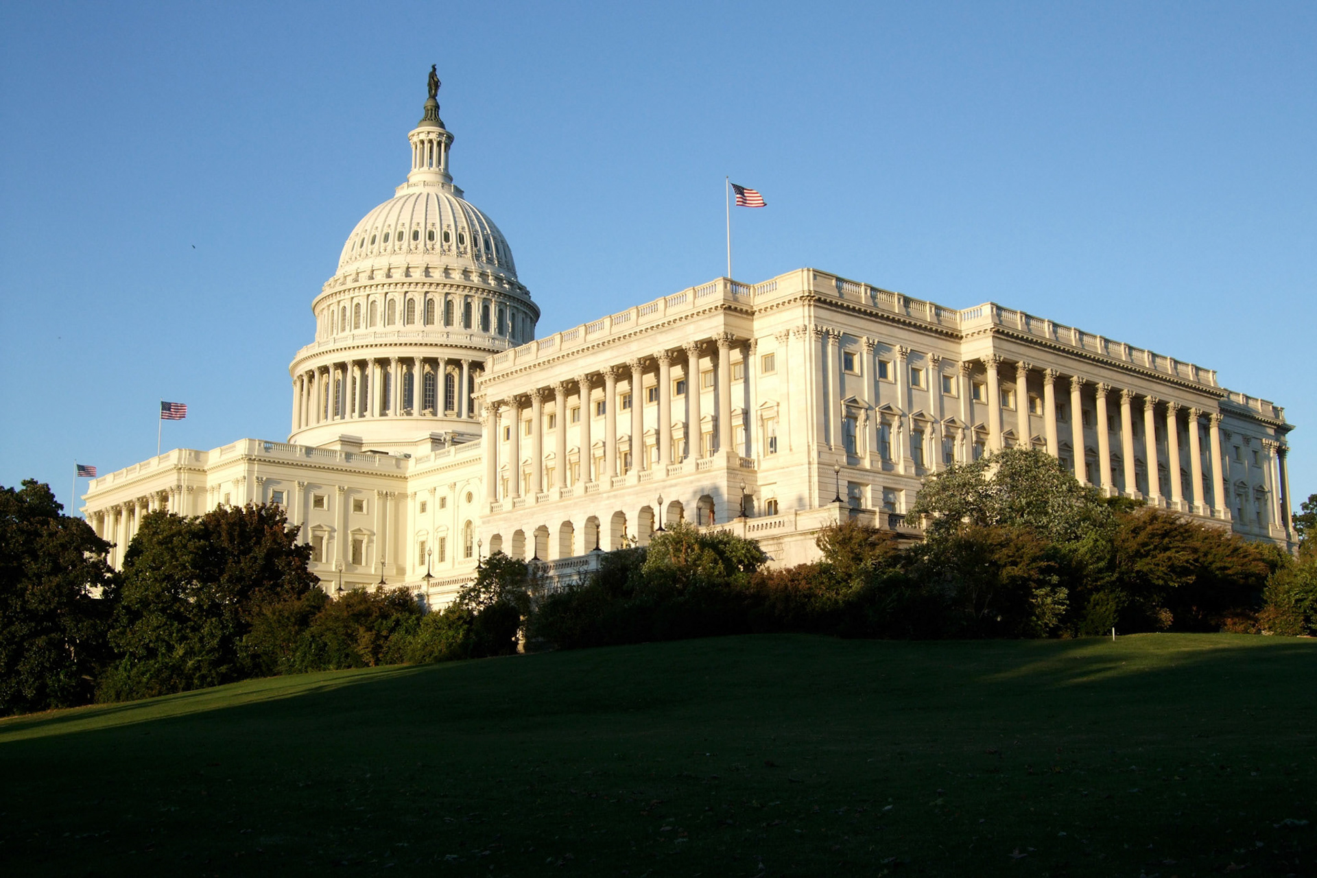 The rear of the Capitol Building. The two centre flags by the dome fly all the time. The two on the far ends fly only when the chamber is in session