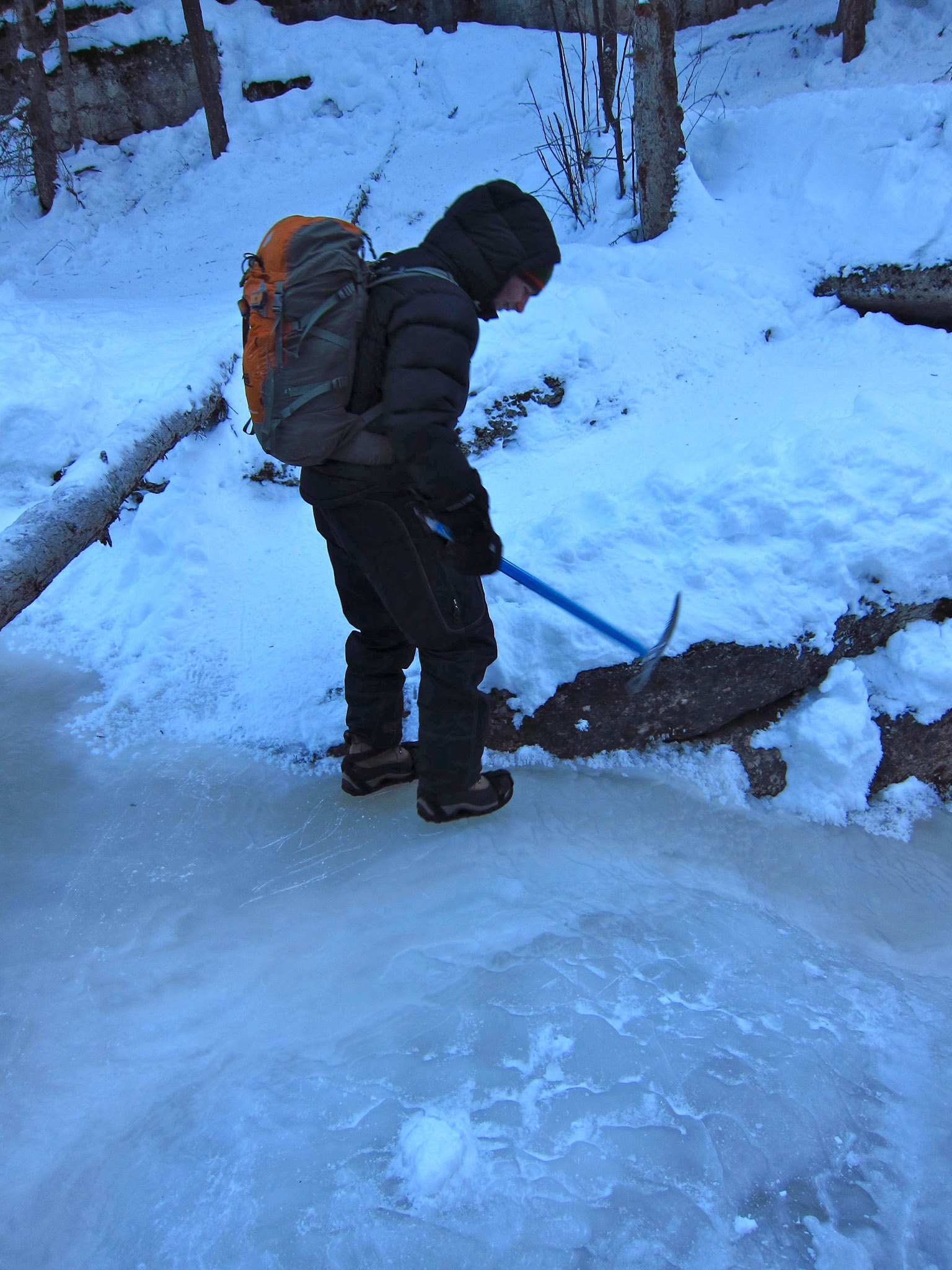Our guide checks the frozen Maligne River for a safe place to walk