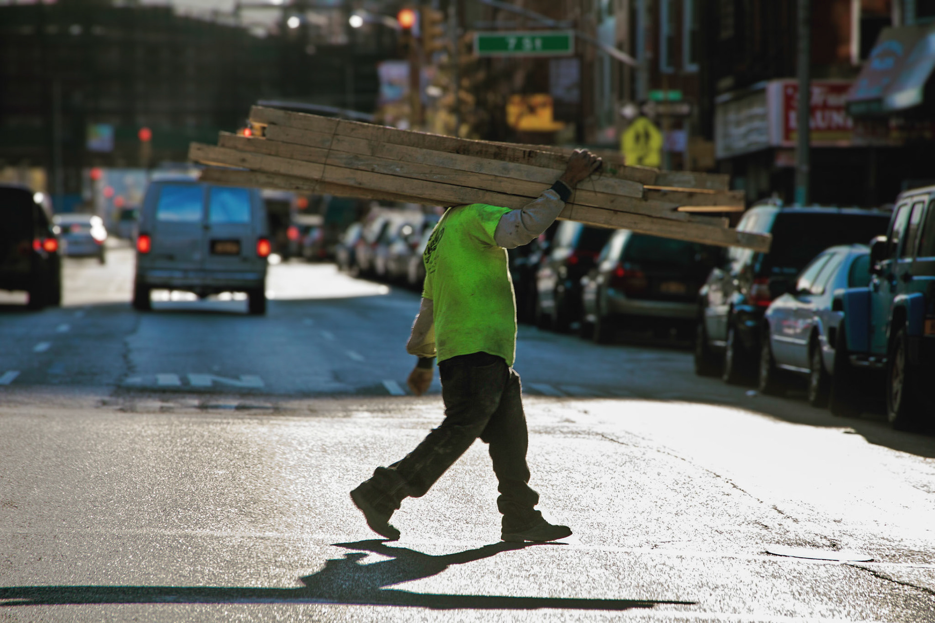 Construction Worker Carrying Lumber