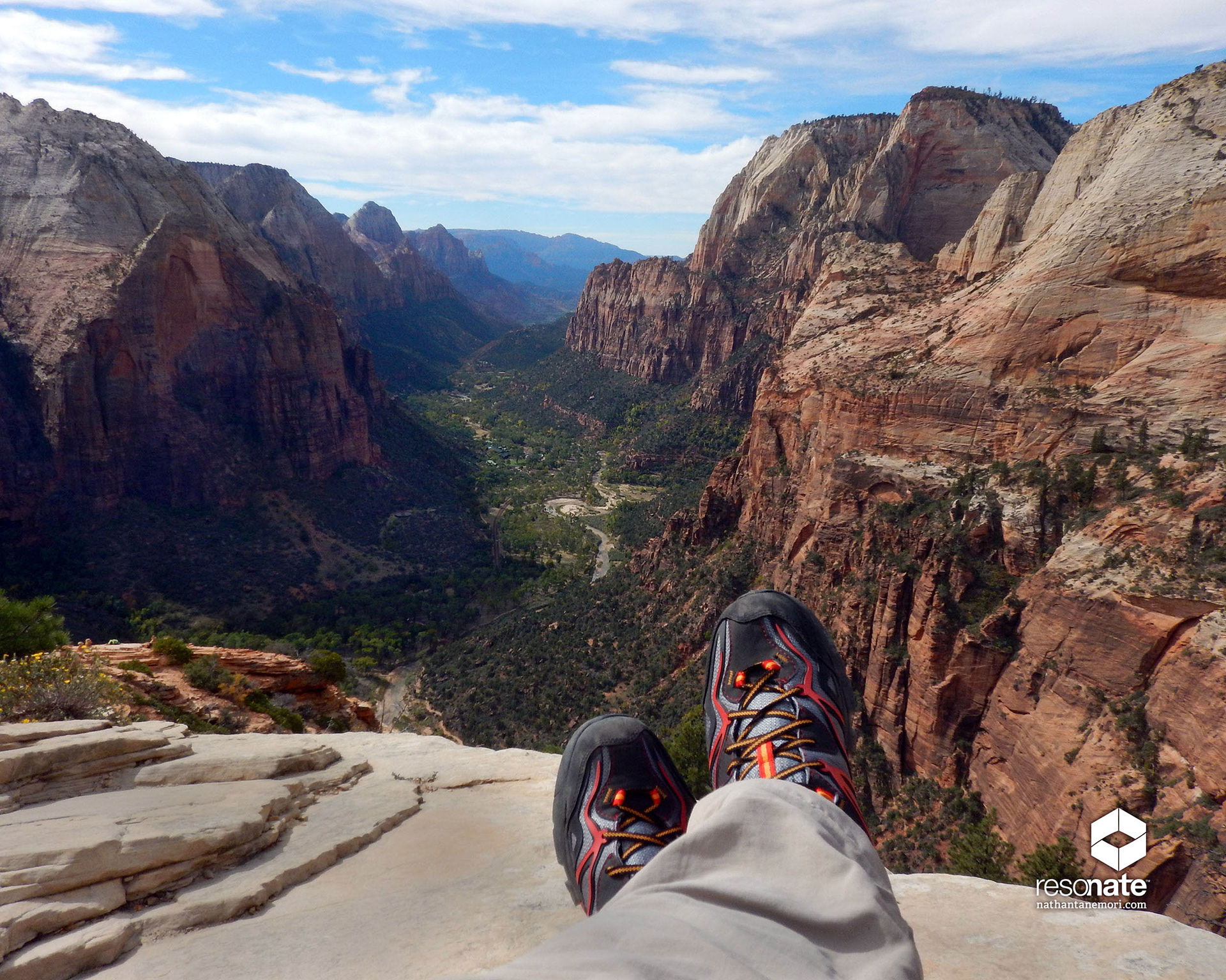 Feet crossed at the edge of a canyon cliff in Utah's Zion National Park.