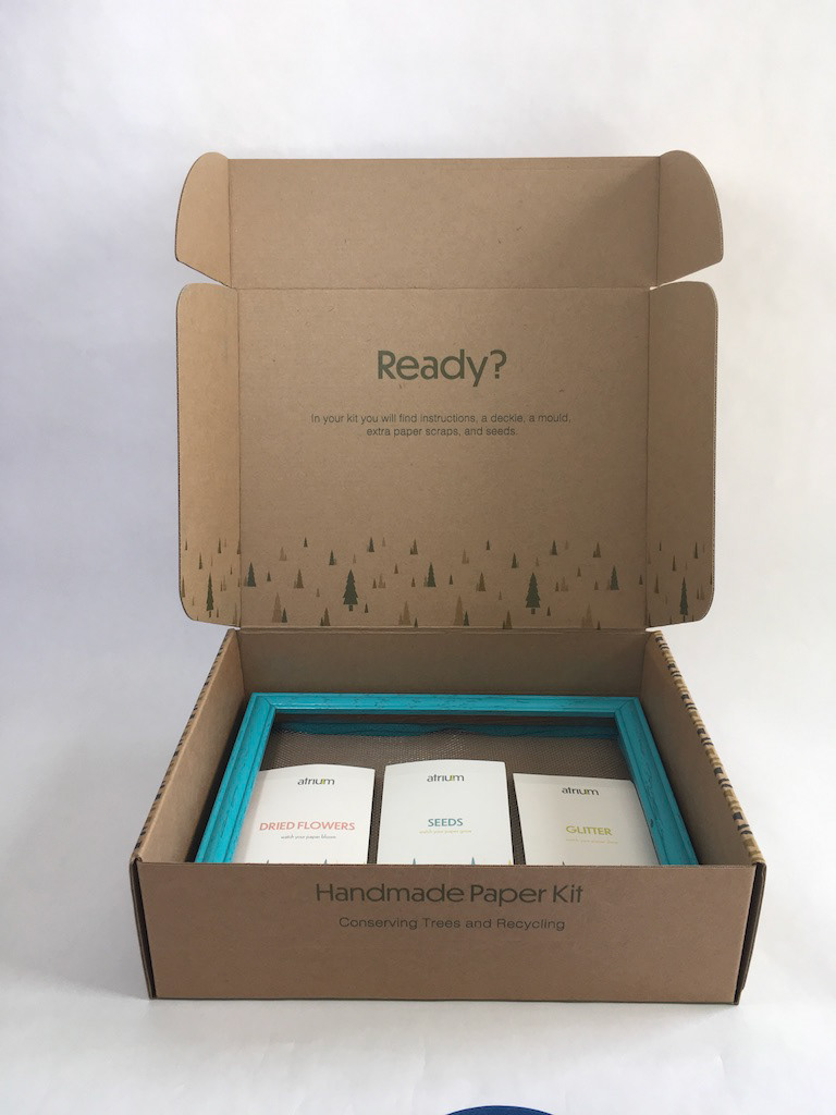 Open box featuring the packets and screens for paper making