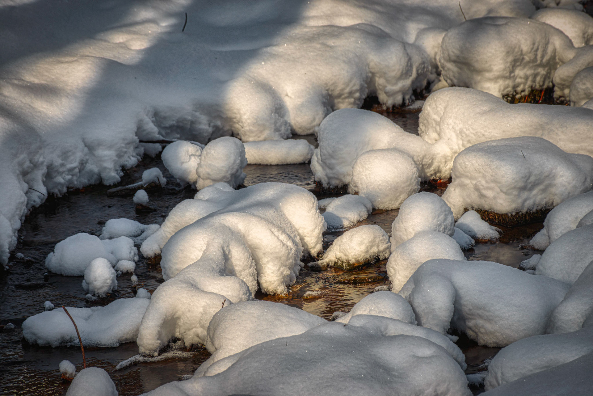 Warm Morning Light on Snow and Rocks in Stream