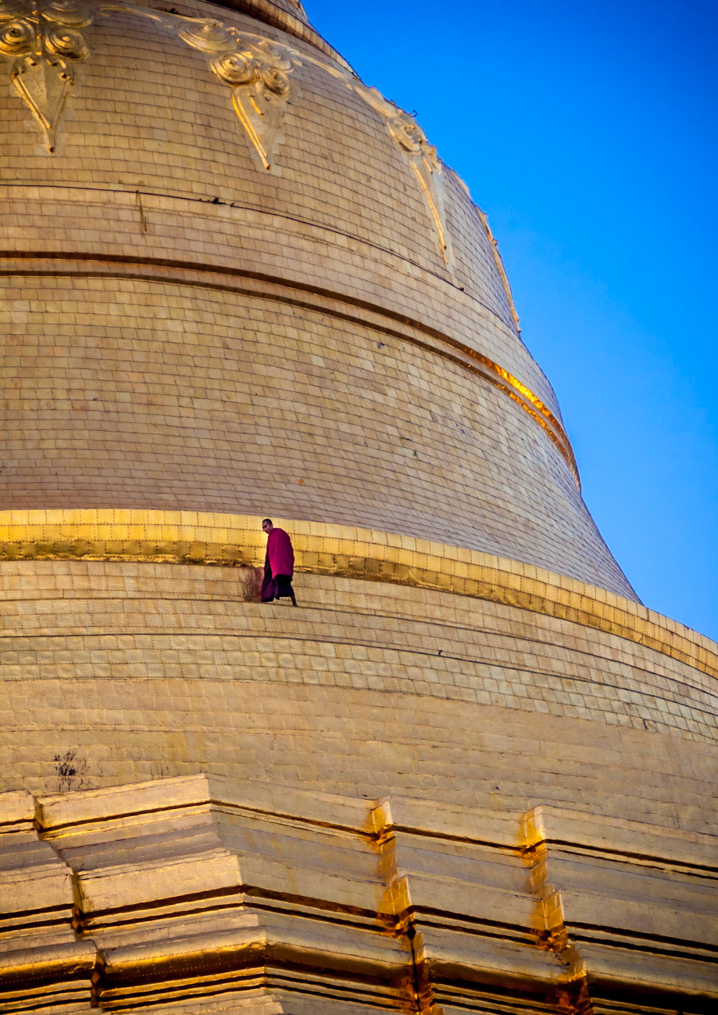 monk climbing Shwedagon-Pagoda in Yangon, Burma