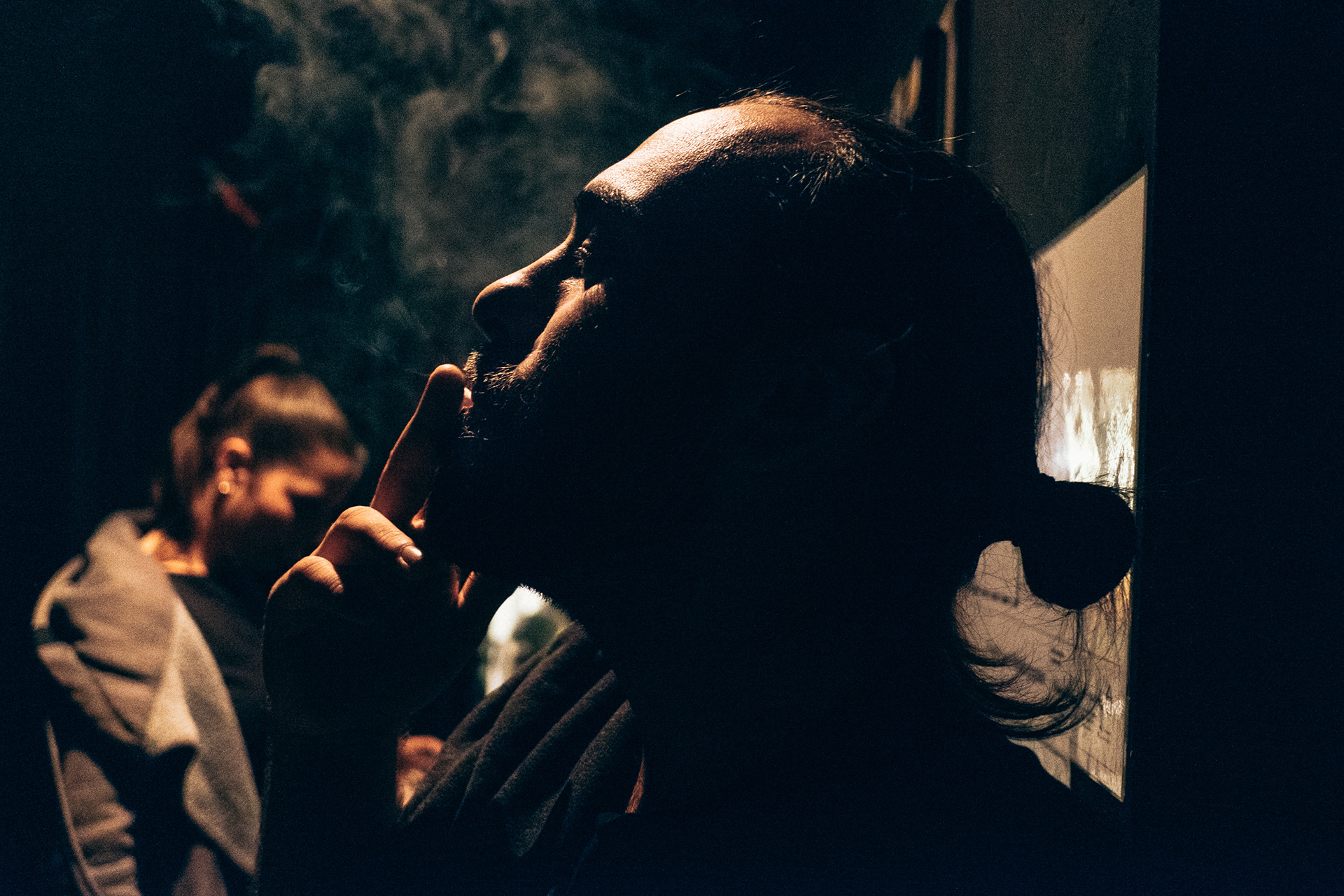Guitar player is smoking a cigarette backstage