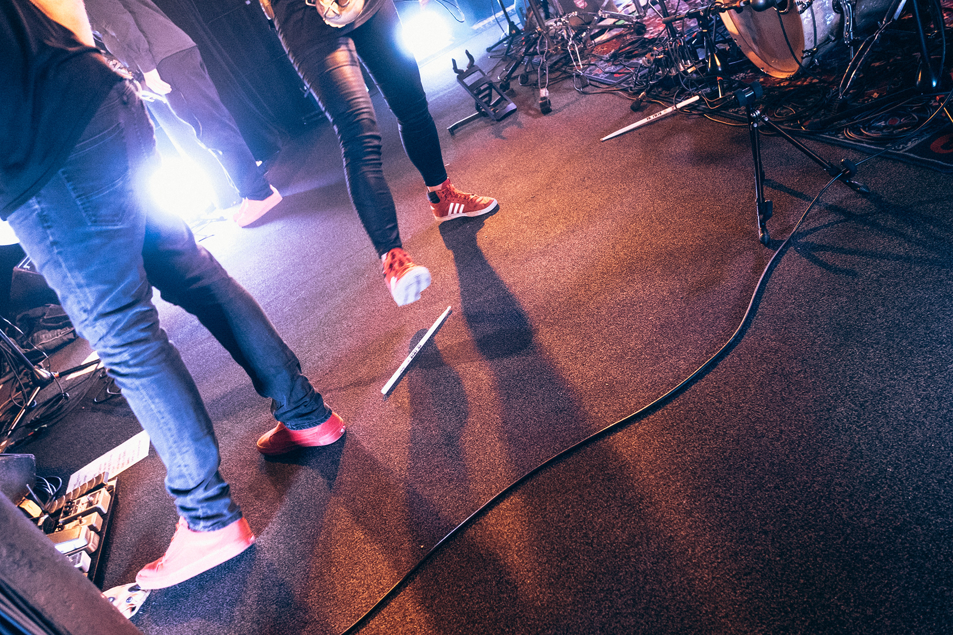 Someone kicking drumsticks on a stage