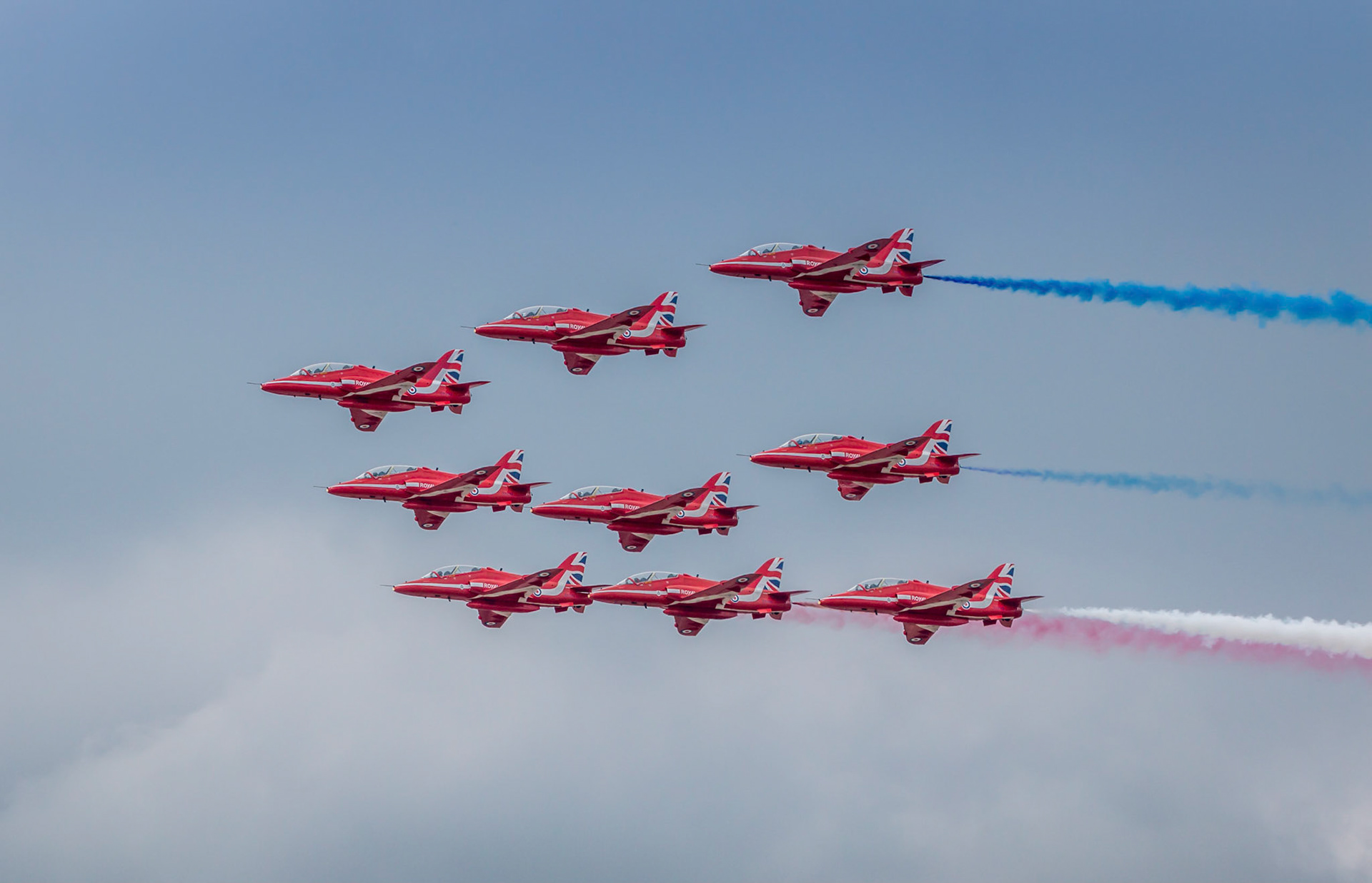 The British Royal Air Force Red Arrows display team. Flying in BAE Hawk T Mk1 Jets. These are the planes that the RAF use to simulate enemy forces during training exercises!