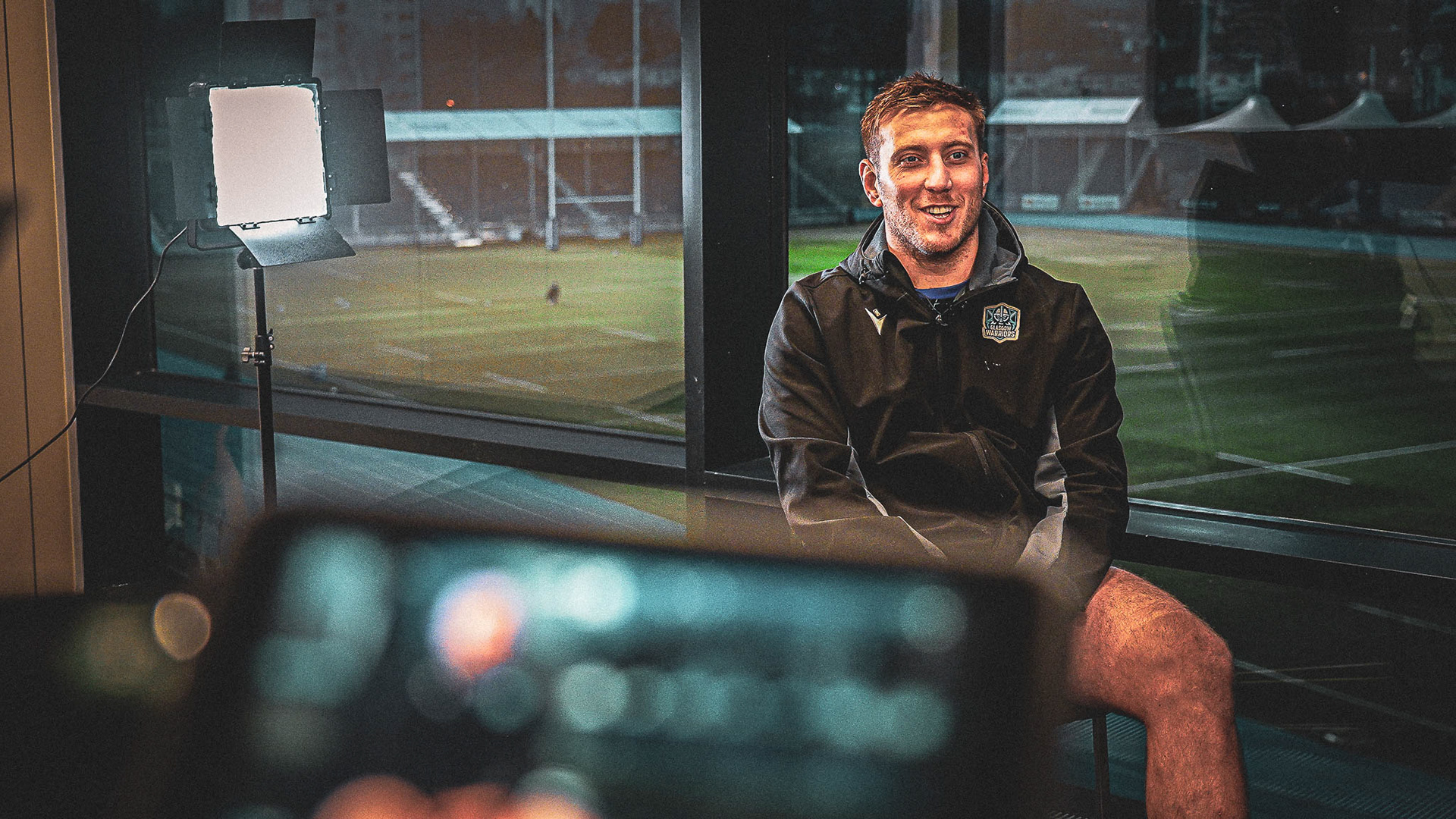 Behind-the-scenes sports documentary interview with athlete, filmed using professional lighting and camera setup in Scotland