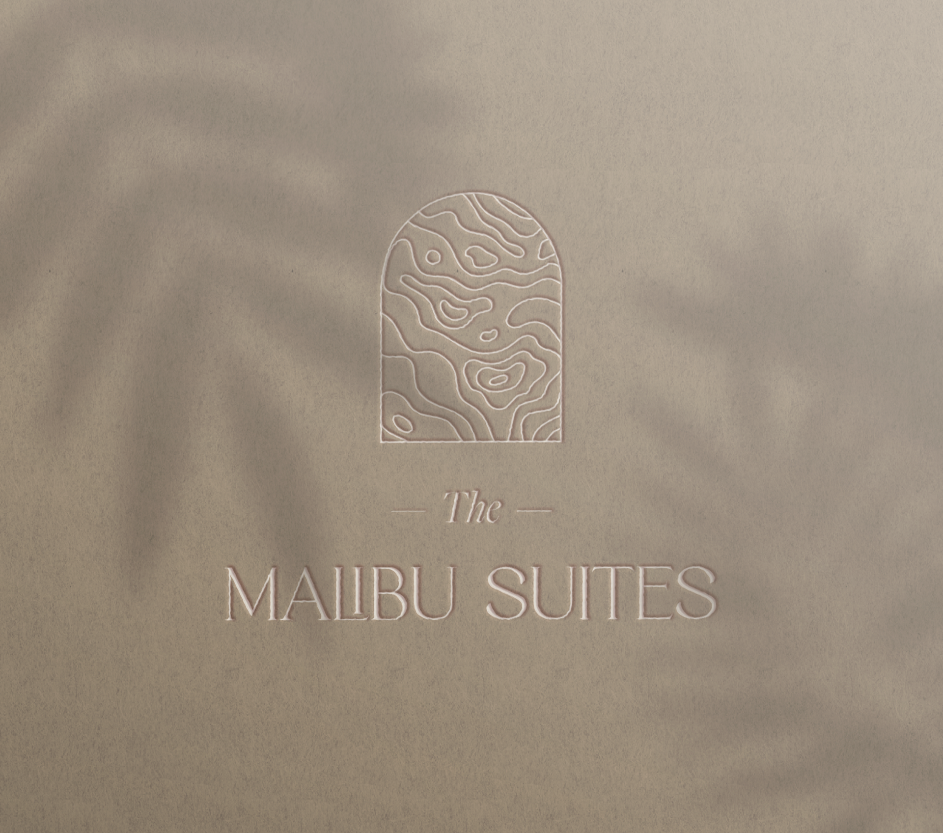 The Malibu Suites logo mockup placed on a building wall
