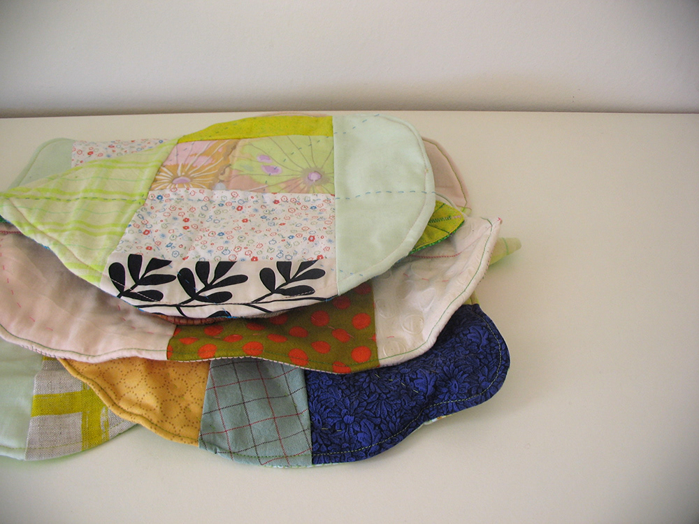 A stack of large sewn leaves of different shapes