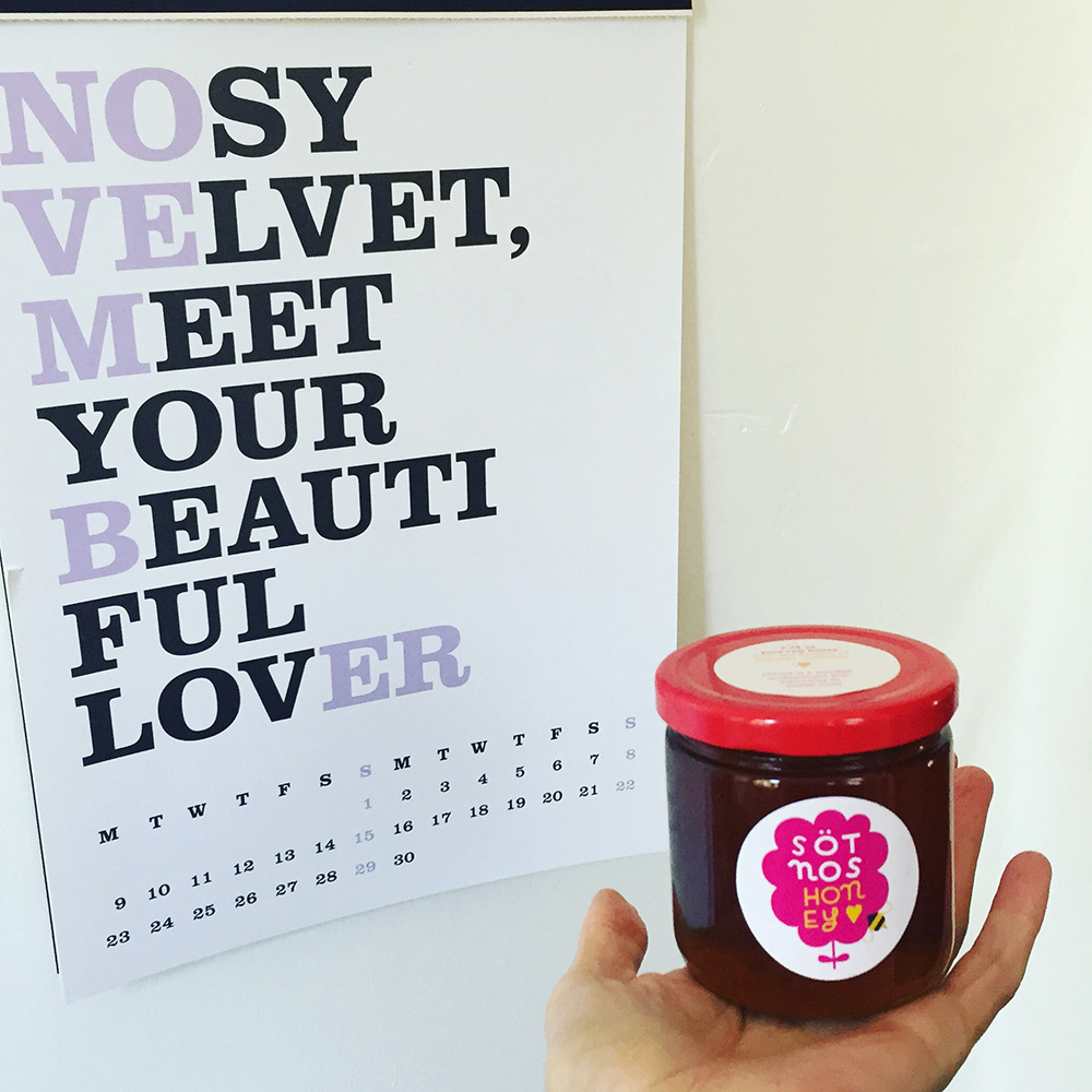 Hand holding a jar of honey with a Sötnos label