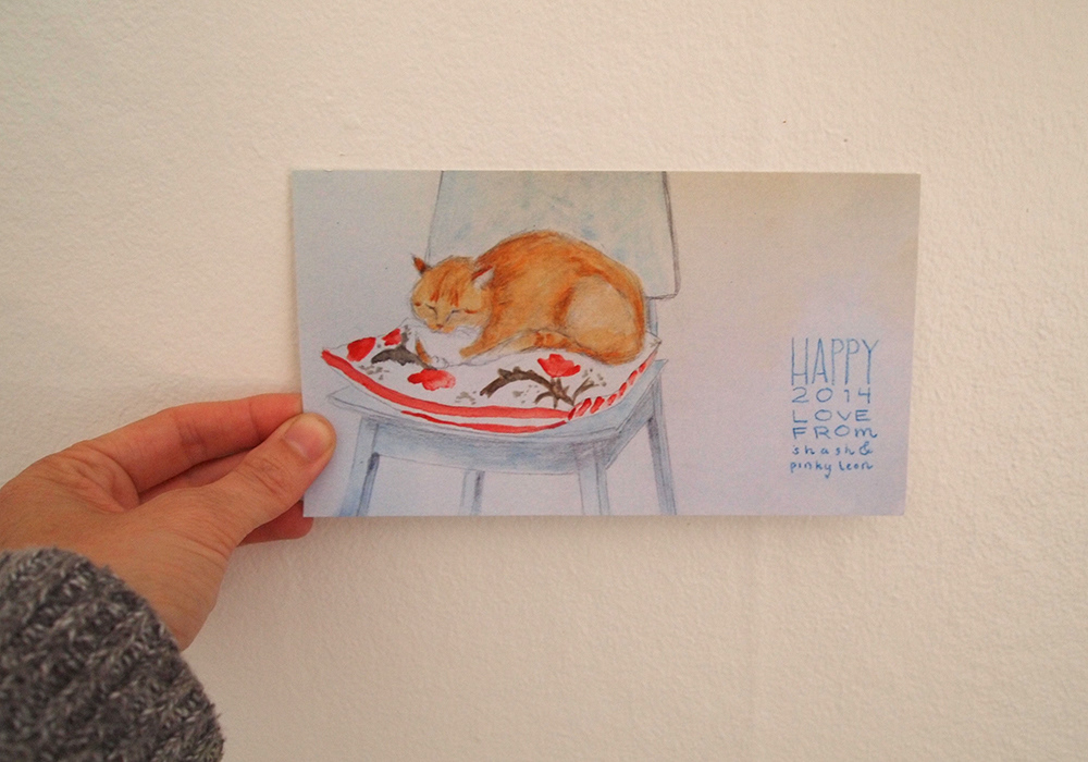 Watercolor of Pinky sleeping on a cushion on a chair