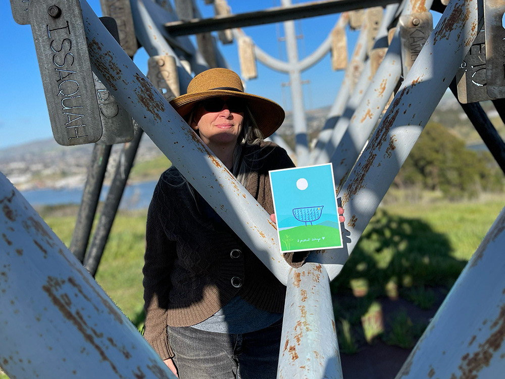 Photo of me inside the Spirit Ship holding the card with the Spirit Ship illustration.